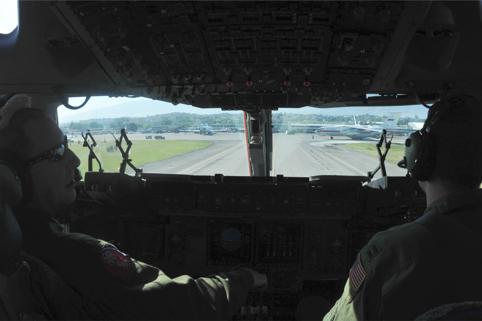 Port au Prince, Haiti – Piloting a C-17 Globemaster III, Lt. Col. Brian Ede, commander of the 58th Airlift Squadron and Capt. John Damron also of the 58 AS, taxi onto the parking ramp at the Toussaint Louverture International Airport in Haiti Jan. 18. The C-17 from Altus AFB, Okla., delivered Army personnel and vehicles in support of Operation Unified Response. Haiti was struck by an earthquake Jan. 12. (U.S. Air Force photo/Senior Airman Amanda Bower)