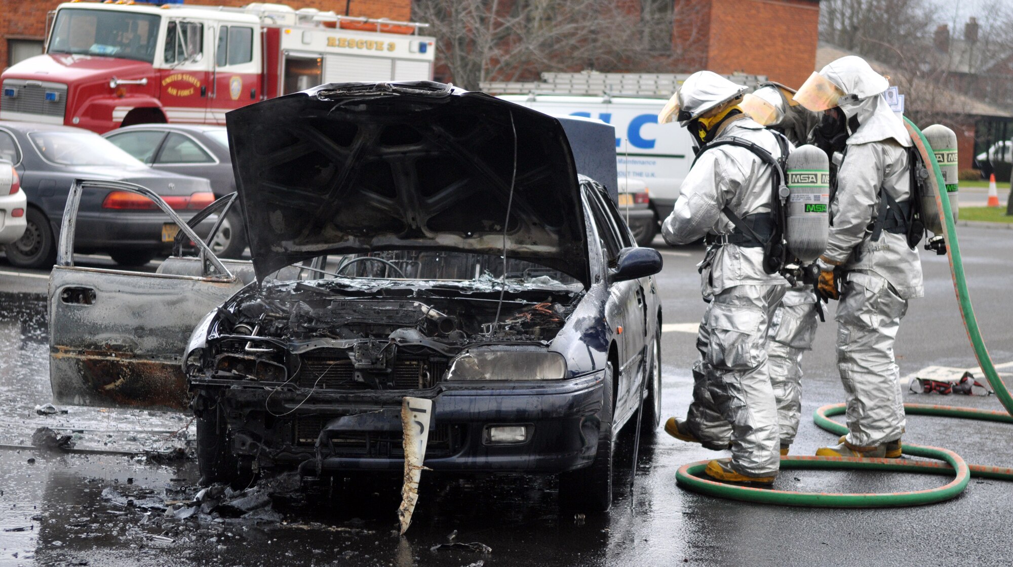 RAF MILDENHALL, England -- Firefighters look for hot spots in a car that caught fire in a parking lot here Jan. 20.  No one was hurt in the blaze, and firefighters put the fire out before it could damage any other vehicles.  The incident is currently under investigation.  (U.S. Air Force photo by Staff Sgt. Austin M. May)