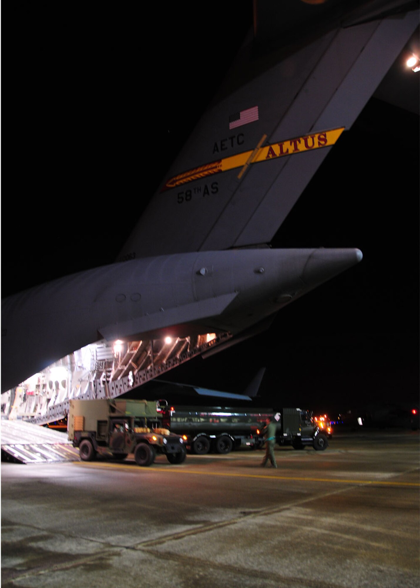 Pope Air Force Base, N.C. – A C-17 Globemaster III from Altus AFB, Okla., is loaded with Army vehicles and personnel from Fort Bragg, N.C., Jan. 18. The 97th Air Mobility Wing committed six C-17s, which will be staged out Pope AFB, to support Operation Unified Response, a humanitarian mission to help Haiti. The island nation was struck by an earthquake Jan. 12. (U.S. Air Force photo/Senior Airman Amanda Bower)