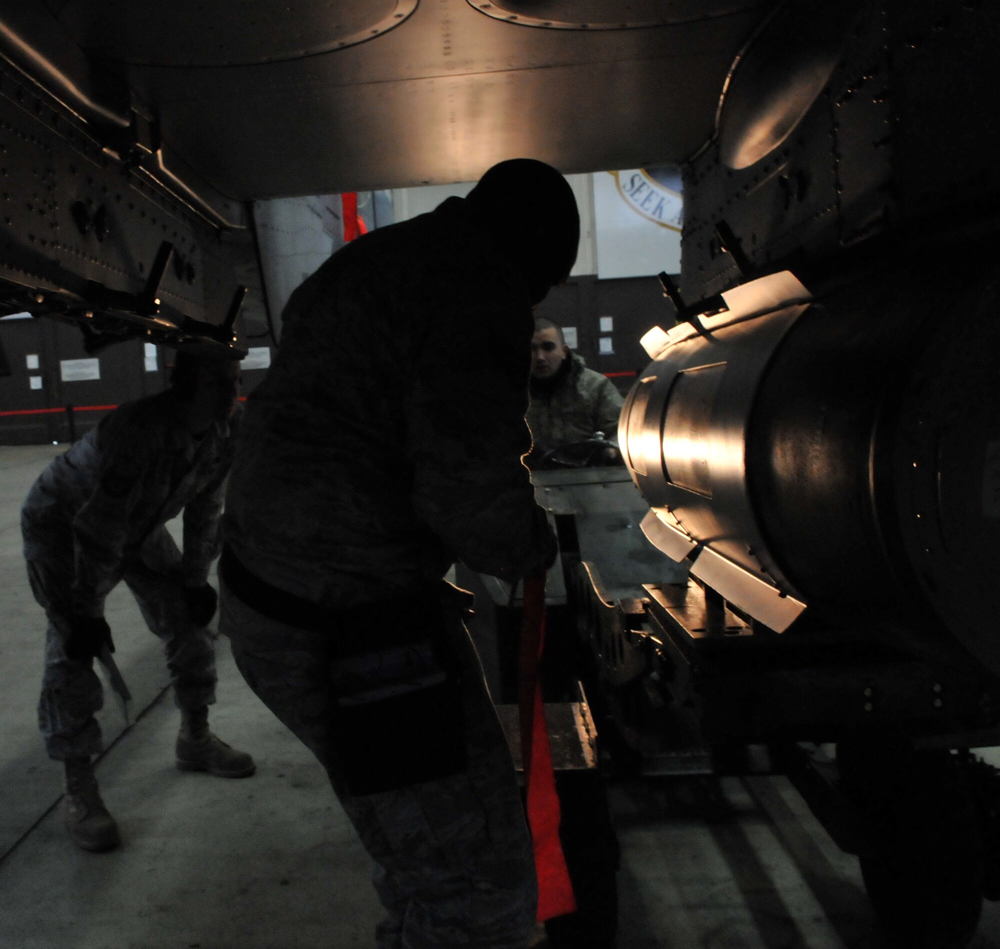 SPANGDAHLEM AIR BASE, Germany -- Staff Sgt. Charles Walker marks loading steps on his loading checklist as Senior Airman Thomas Hanes, 52nd Aircraft Maintenance Squadron, positions a 2,000-pound joint direct attack munition for loading and inspector Tech. Sgt. Richie Bill, 52nd AMXS, observes during the 52nd Fighter Wing Weapons Load Crew of the Year Competition Jan. 15. When following steps on a loading checklist, checklist status must be followed for 100 percent accuracy to ensure a safe and reliable load. . The 52 FW LCOY competition placed load crews from 2009's Weapons Load Crew of the Quarter competitions against each other to crown the weapons load crew of the year and consisted of a dress and appearance and composite tool-box inspection. The competition is still in action, and the winner has not yet been announced as the second quarter weapons load crew winning team is deployed. The contenders in the competition are from the 22nd, 23rd and 81st Aircraft Maintenance Units, and the winner will be announced Feb. 27 at the 52nd Maintenance Group Annual Awards Banquet. (U.S. Air Force photo/Airman 1st Class Nick Wilson)
