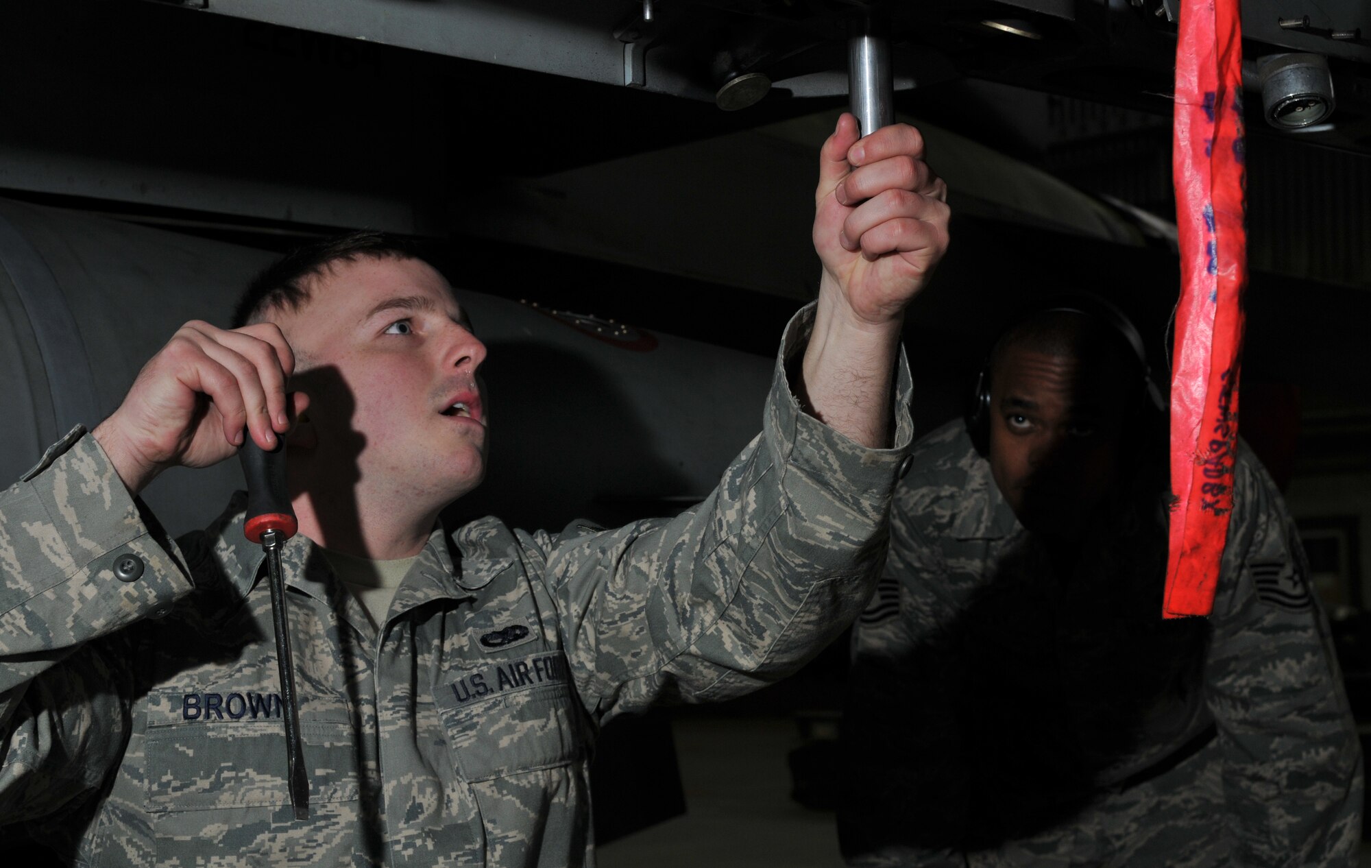SPANGDAHLEM AIR BASE, Germany -- Airman 1st Class Travis Brown, 52nd Aircraft Maintenance Squadron, performs a bomb rack preparation as Tech. Sgt. John Easley, 52nd AMXS, inspects during the 52nd Fighter Wing Weapons Load Crew of the Year Competition Jan. 15.  A bomb rack preparation is essential to ensure bomb racks are prepared for loading. . The 52 FW LCOY competition placed load crews from 2009's Weapons Load Crew of the Quarter competitions against each other to crown the weapons load crew of the year and consisted of a dress and appearance and composite tool-box inspection. The competition is still in action, and the winner has not yet been announced as the second quarter weapons load crew winning team is deployed. The contenders in the competition are from the 22nd, 23rd and 81st Aircraft Maintenance Units, and the winner will be announced Feb. 27 at the 52nd Maintenance Group Annual Awards Banquet. (U.S. Air Force photo/Airman 1st Class Nick Wilson)