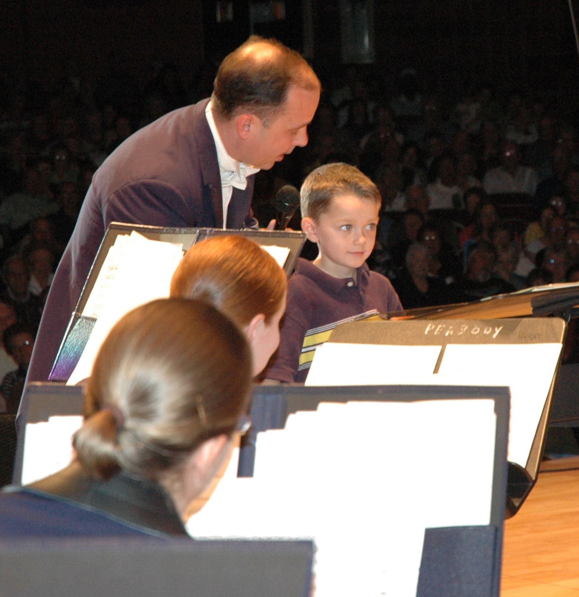 Maj. Don Schofield, Band of the U.S. Air Force Reserve commander, guides an audience member in conducting the band during a performance Jan. 28, 2009. The band will begin another concert tour in southern Georgia and Florida on Jan. 28, 2010. (U.S. Air Force photo)

