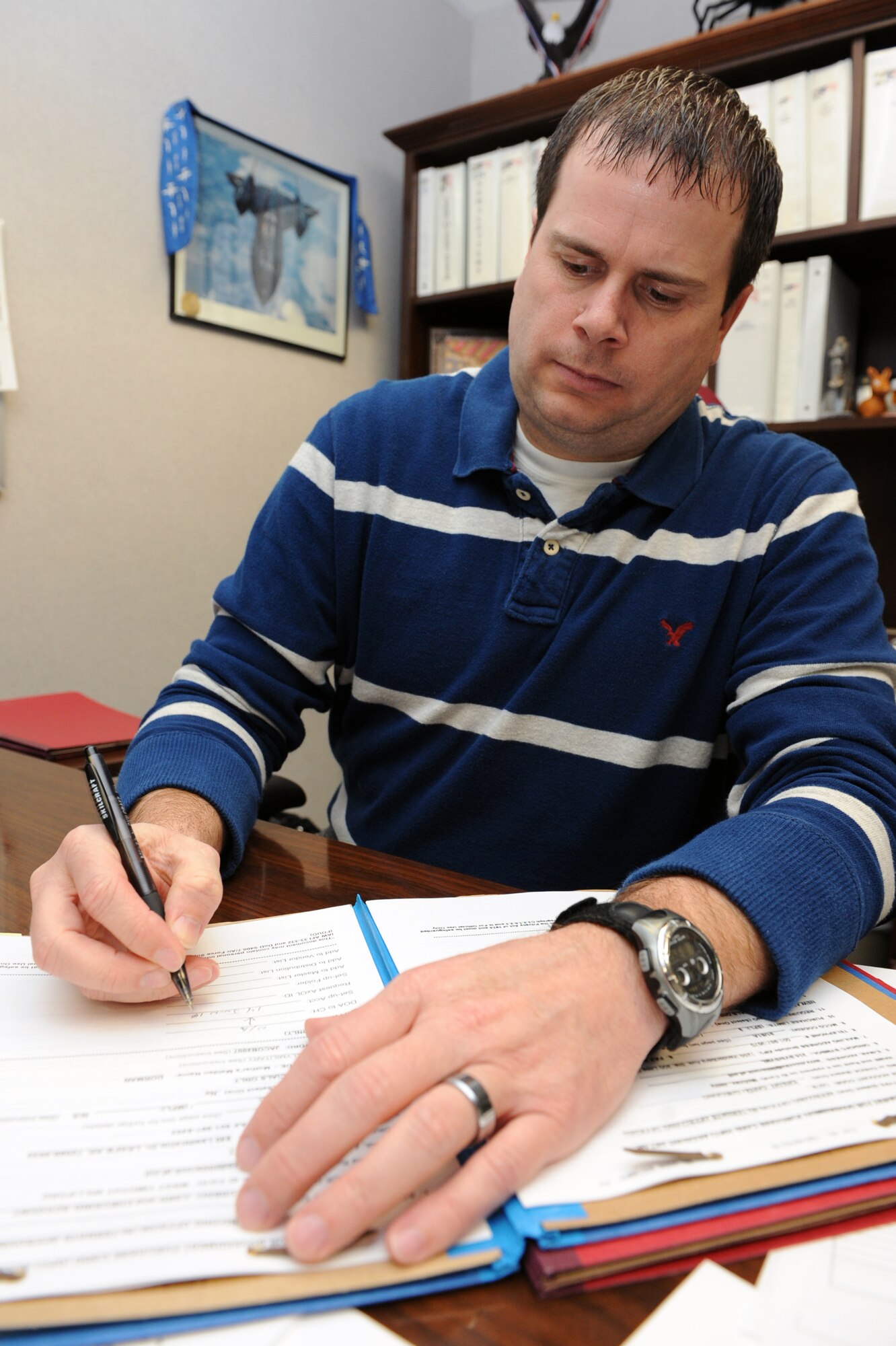 Michael Bittner reviews a folder for the government purchase card program to see how he can better improve the program. He’s always looking to improve the program and provide Team Little Rock’s cardholders and approving officials the best tools and training to accomplish the mission. (U.S. Air Force photo by Senior Airman Ethan Morgan)