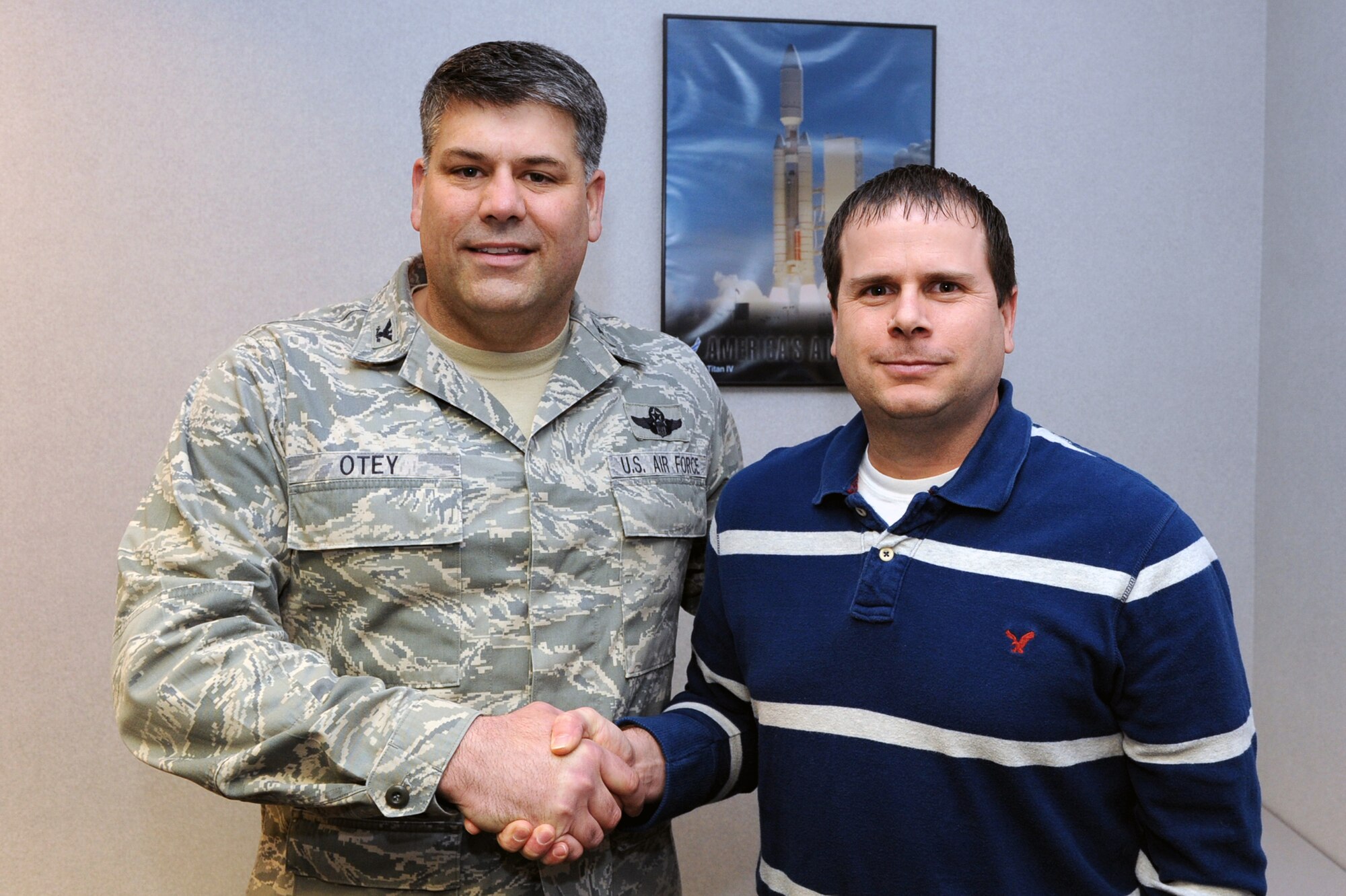 Col. Greg Otey, 19th Airlift Wing commander, presents Michael Bittner, 19th Contracting Squadron government-wide purchase card program manager, a commander’s coin Jan. 19 for being selected as the Little Rock Air Force Base Combat Airlifter of the Week. Mr. Bittner was selected for Combat Airlifter of the Week for maintaining an $18.3 million wing program, which includes a 30 percent increase over the prior year. (U.S. Air Force photo by Senior Airman Ethan Morgan)