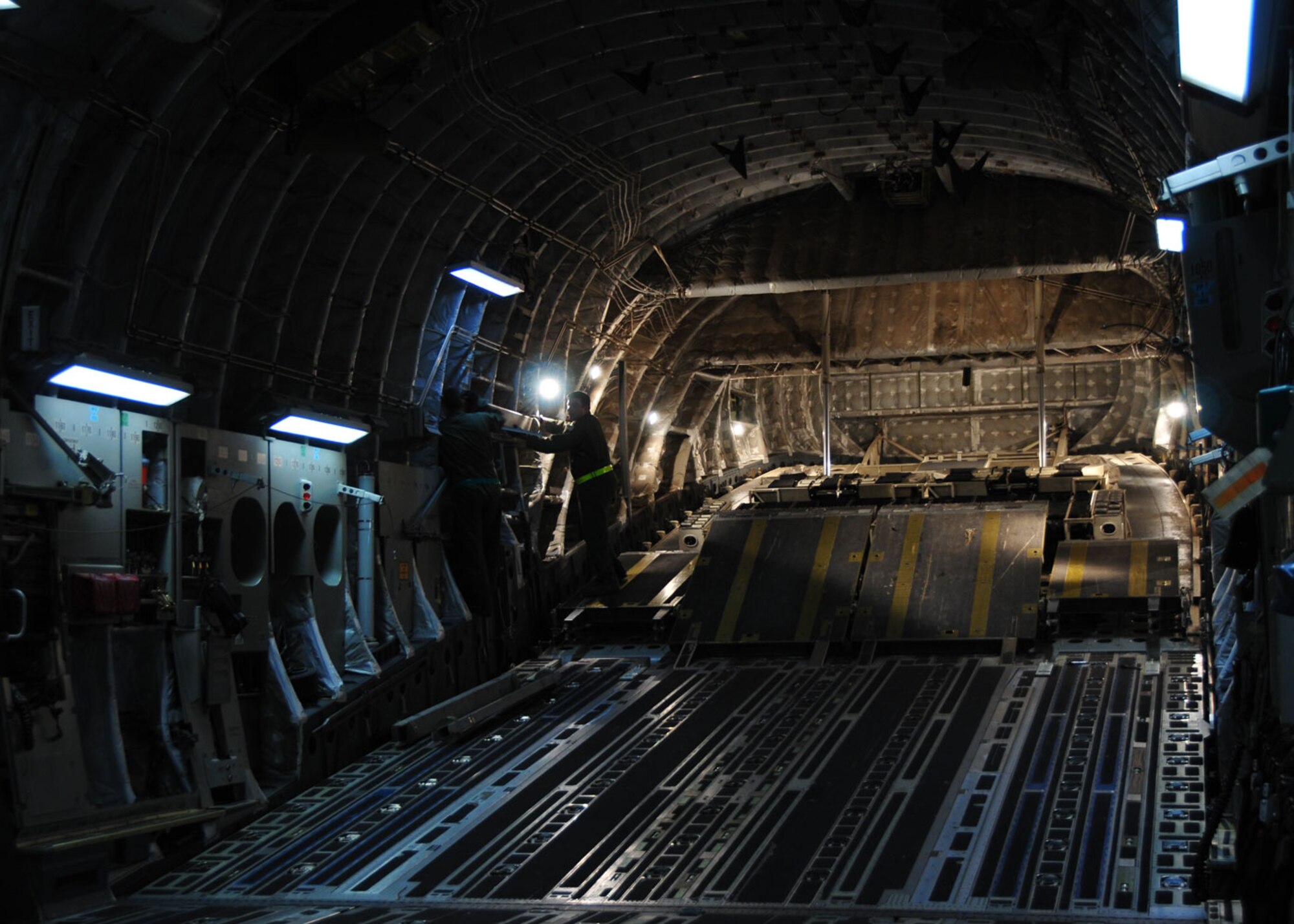 Pope Air Force Base, N.C. – Tech. Sergeants Michael Morris and Joshua Piper, loadmasters from the 58th Airlift Squadron at Altus AFB, Okla., prepare an Altus C-17 Globemaster III for the loading of Army vehicles and personnel en route to Port au Prince, Haiti, in support of Operation Unified Response. Altus has six aircraft flying sorties out of Pope AFB to support the humanitarian mission at Haiti. (U.S. Air Force photo/Senior Airman Amanda Bower)