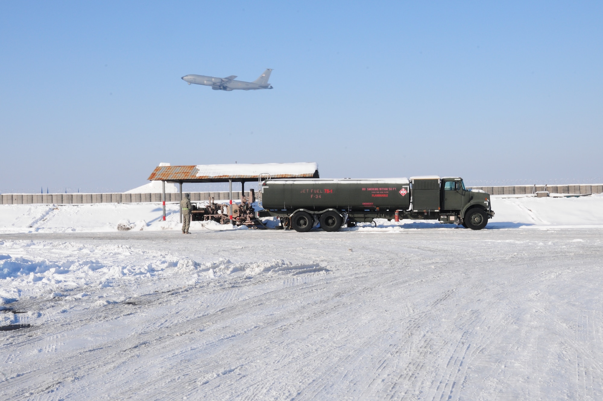 A KC-135 Stratotanker takes off at the Transit Center at Manas, Kyrgyzstan, Jan. 19, 2010.  The 376th Expeditionary Logistics Readiness Squadron petroleum, oil and lubricants flight here was the first in the AOR to implement a new pre-filter system for fuel which will save time and money and deliver better, cleaner fuel to the aircraft the KC-135 refuels. Saving both money and time, it’s a simple process, but it has a huge impact considering that the tankers here go through several thousand gallons a day. This air-to-air refueling is what allows coalition aircraft to stay in the fight over Afghanistan. (U.S. Air Force photo/Senior Airman Nichelle Anderson/Released)