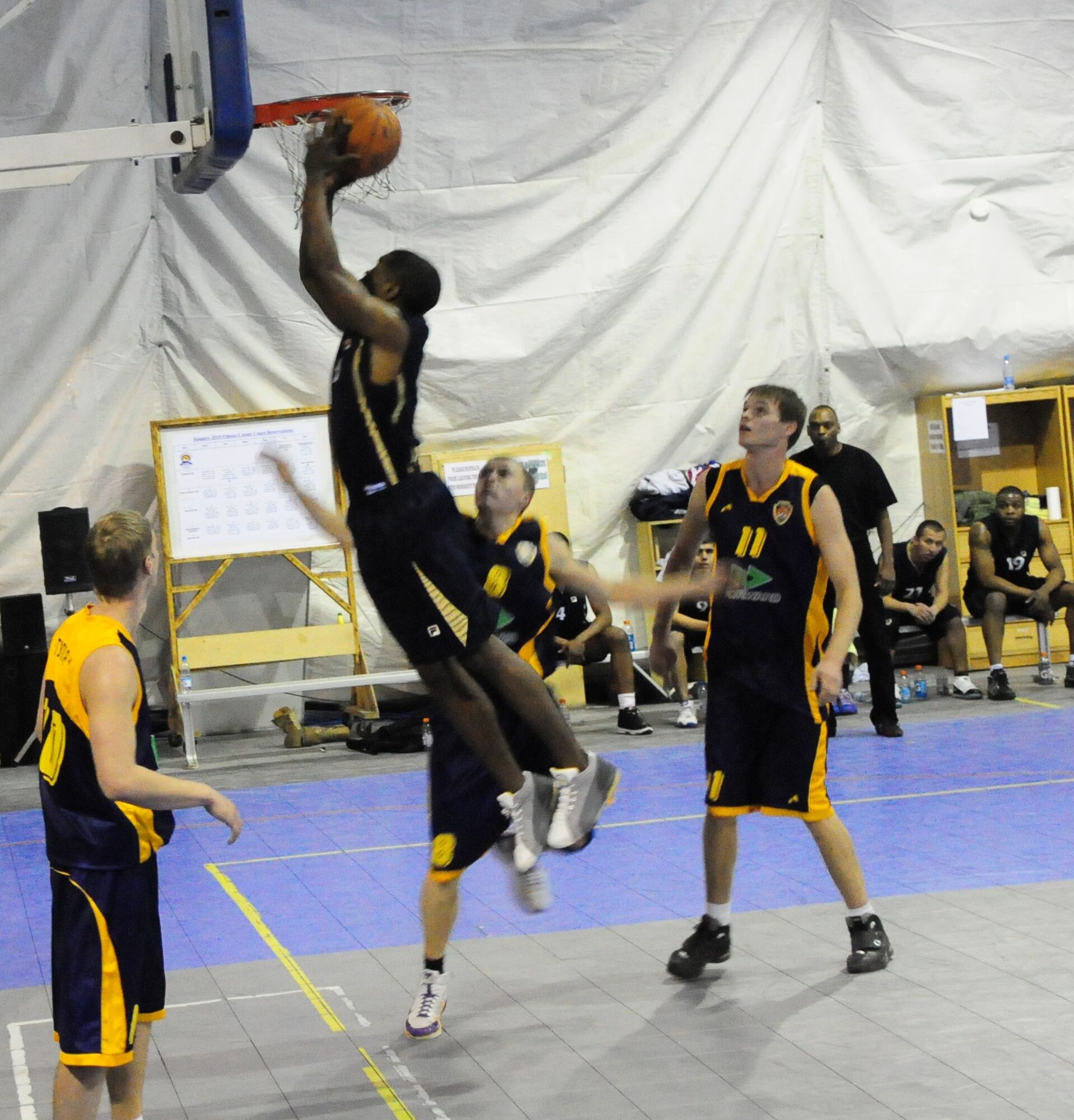 A U.S. Air Force member of the Transit Center at Manas basketball team drives in for a layup during a good will game against the Academy of Physical Culture and Sports, Jan. 19, 2010. The APCS defeated the TC team 72-55. (U.S. Air Force photo/Senior Master Sgt. Mike Litsey/released)