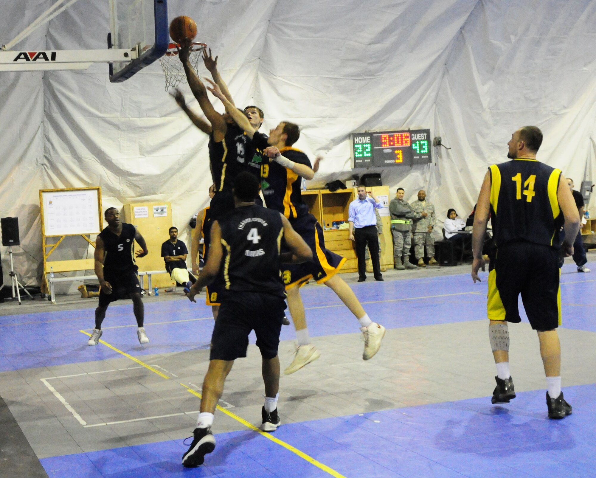 A U.S. Air Force member of the Transit Center at Manas basketball team shoots a layup between two defenders during a good will game against the Academy of Physical Culture and Sports, Jan. 19, 2010. The APCS defeated the TC team 72-55.  (U.S. Air Force photo/Senior Master Sgt. Mike Litsey/released)