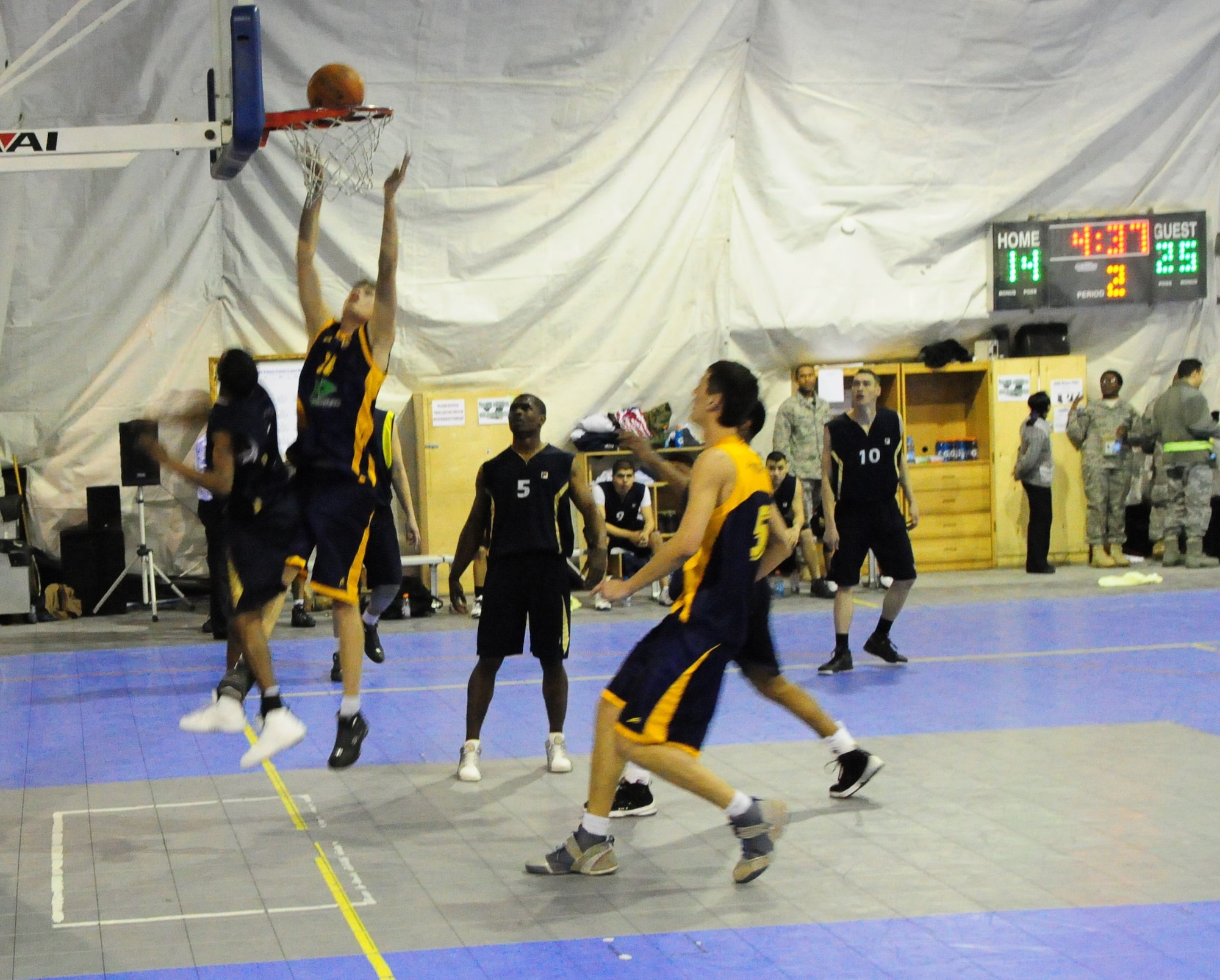 A student of the Academy of Physical Culture and Sports goes high for a tip in during a good will basketball game against U.S. Air Force members from the Transit Center at Manas, Kyrgyzstan, Jan. 19, 2010. The APCS defeated the TC team 72-55. (U.S. Air Force photo/Senior Master Sgt. Mike Litsey/released)
