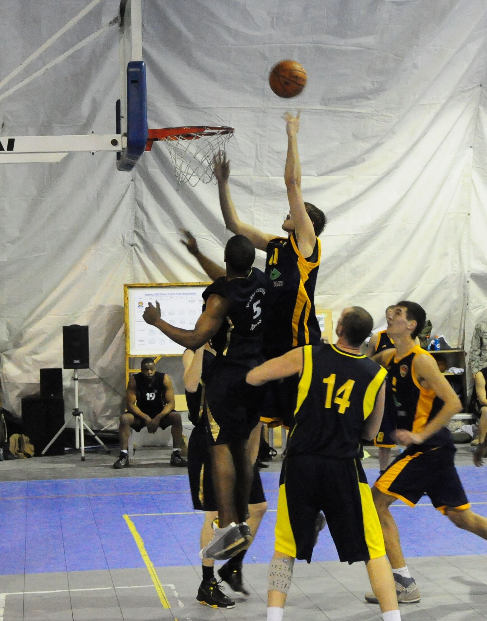 A student of the Academy of Physical Culture and Sports goes high for a tip in during a good will basketball game against U.S. Air Force members from the Transit Center at Manas, Kyrgyzstan, Jan. 19, 2010. The APCS defeated the TC team 72-55. (U.S. Air Force photo/Senior Master Sgt. Mike Litsey/released)