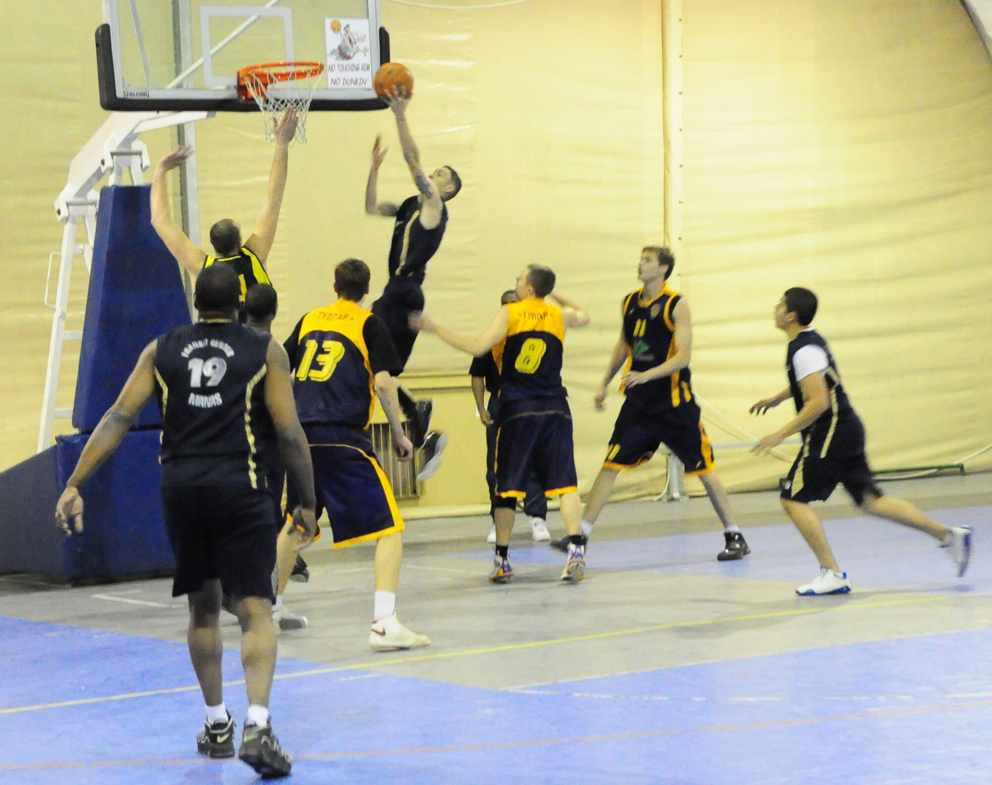 A Marine, member of the Transit Center at Manas basketball team, drives in for a layup during a good will game against the Academy of Physical Culture and Sports, Jan. 19, 2010. The APCS defeated the TC team 72-55. (U.S. Air Force photo/Senior Master Sgt. Mike Litsey/released)