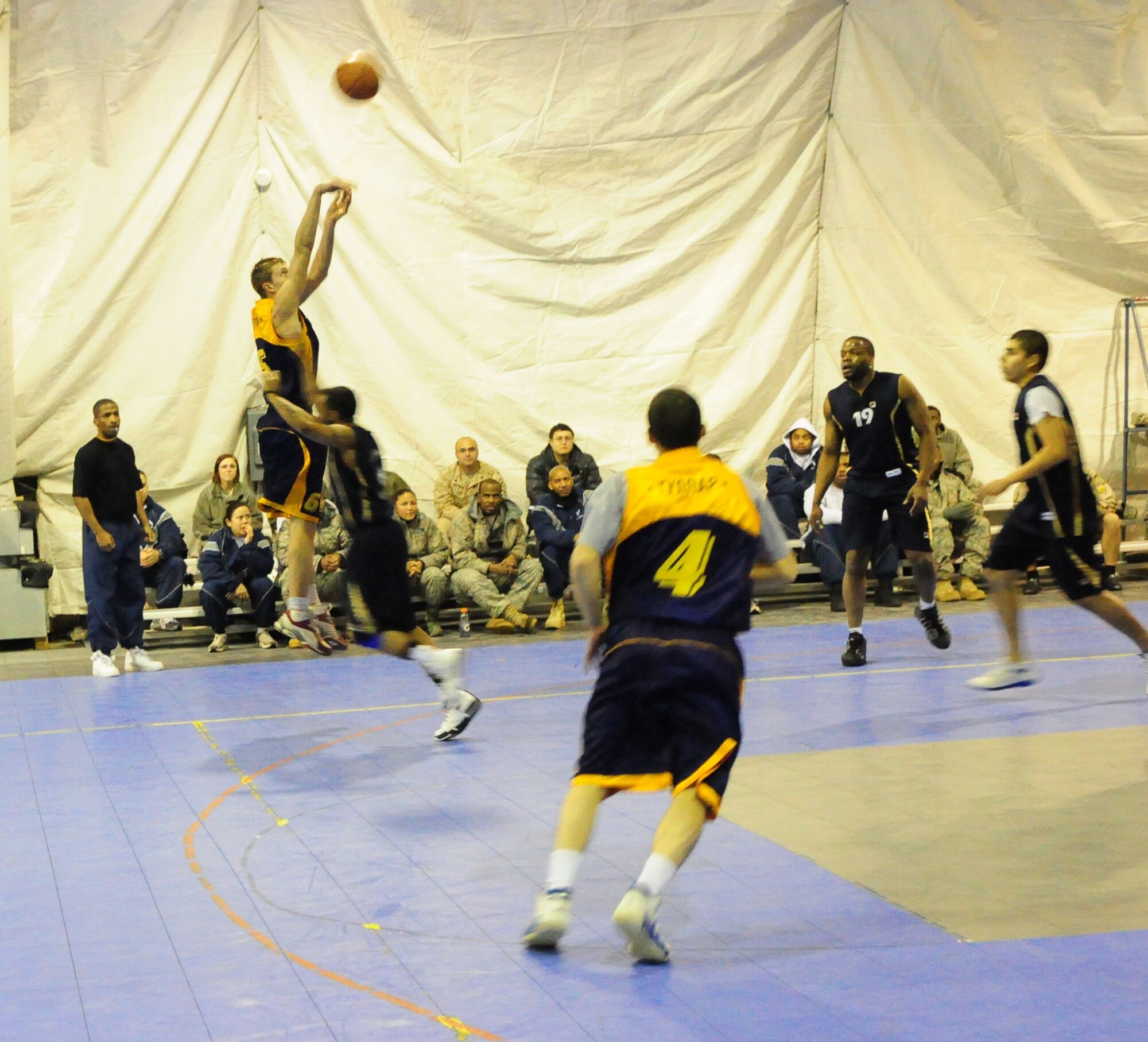 A student of the Academy of Physical Culture and Sports shoots a three-point shot during a good will basketball game against U.S. Air Force members from the Transit Center at Manas, Kyrgyzstan, Jan. 19, 2010. The APCS defeated the TC team 72-55. (U.S. Air Force photo/Senior Master Sgt. Mike Litsey/released)