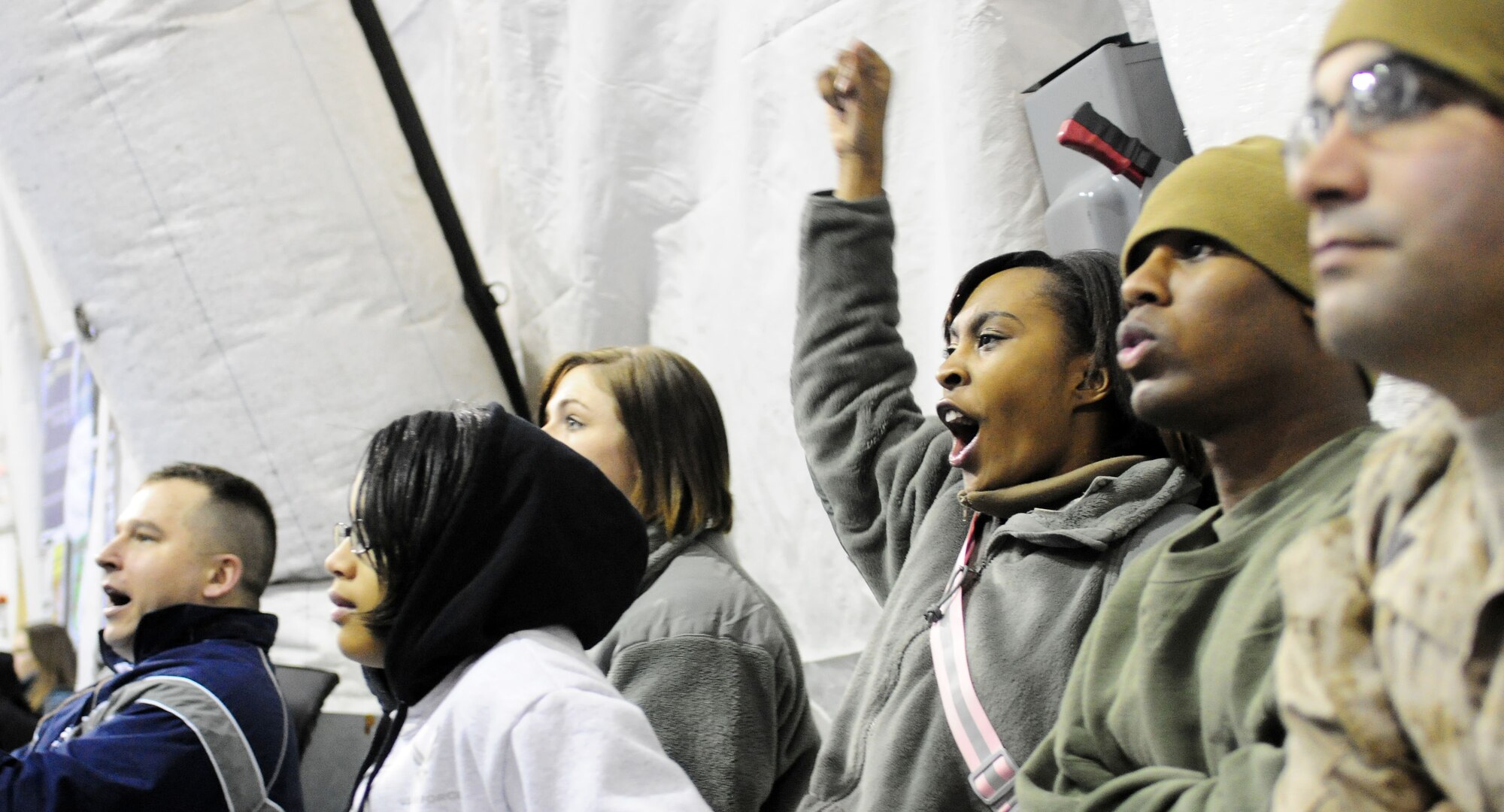 U.S. spectators watch a basketball game at the Transit Center at Manas, Kyrgyzstan, Jan. 19, 2010. The APCS defeated the TC team 72-55. In spite of the score, the good will competition was jam-packed with sportsmanship and hard play. (U.S. Air Force photo/Senior Airman Nichelle Anderson/released)