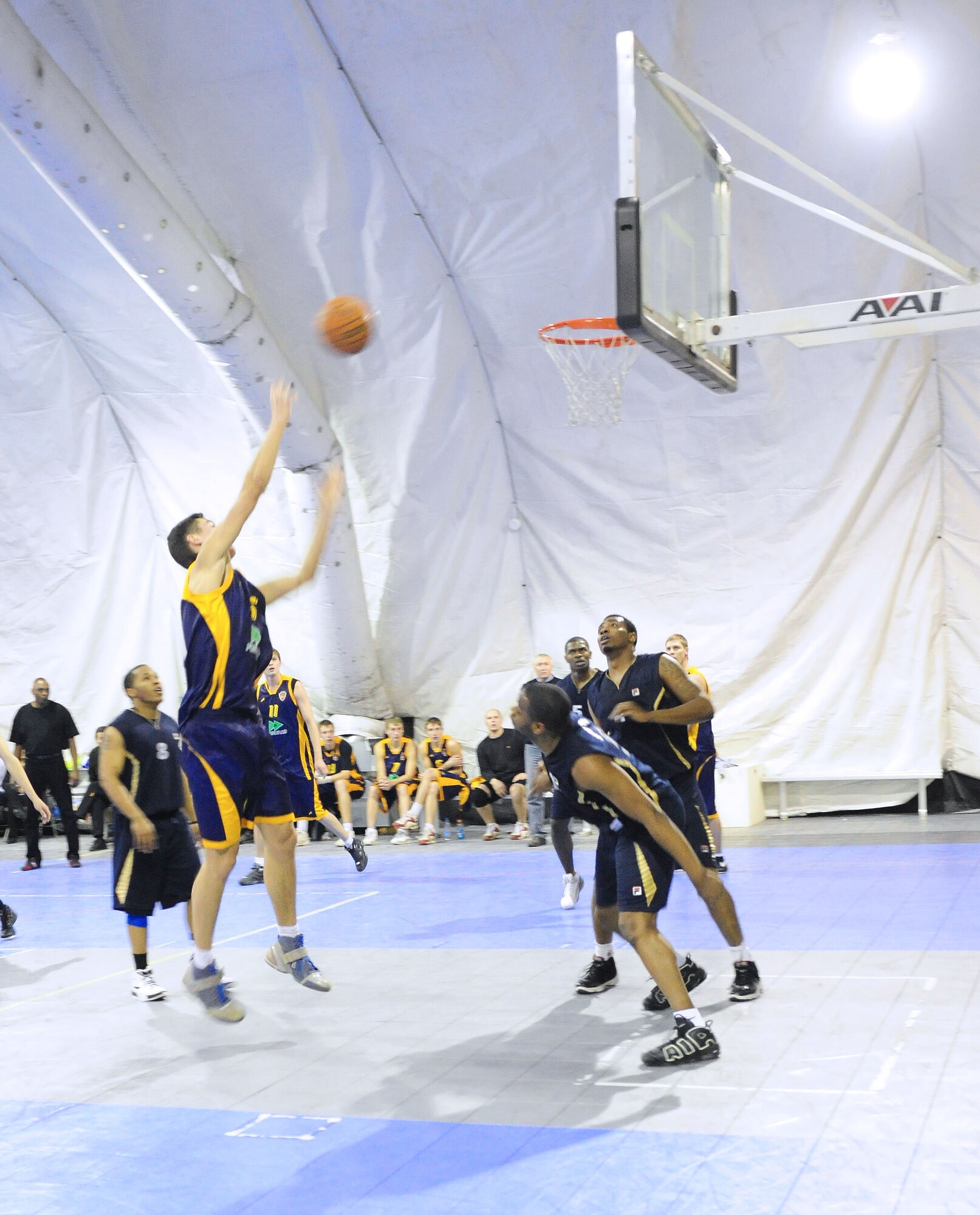 A student of the Academy of Physical Culture and Sports goes up for a shot during a good will basketball game against U.S. Air Force members from the Transit Center at Manas, Kyrgyzstan, Jan. 19, 2010. The APCS defeated the TC team 72-55.