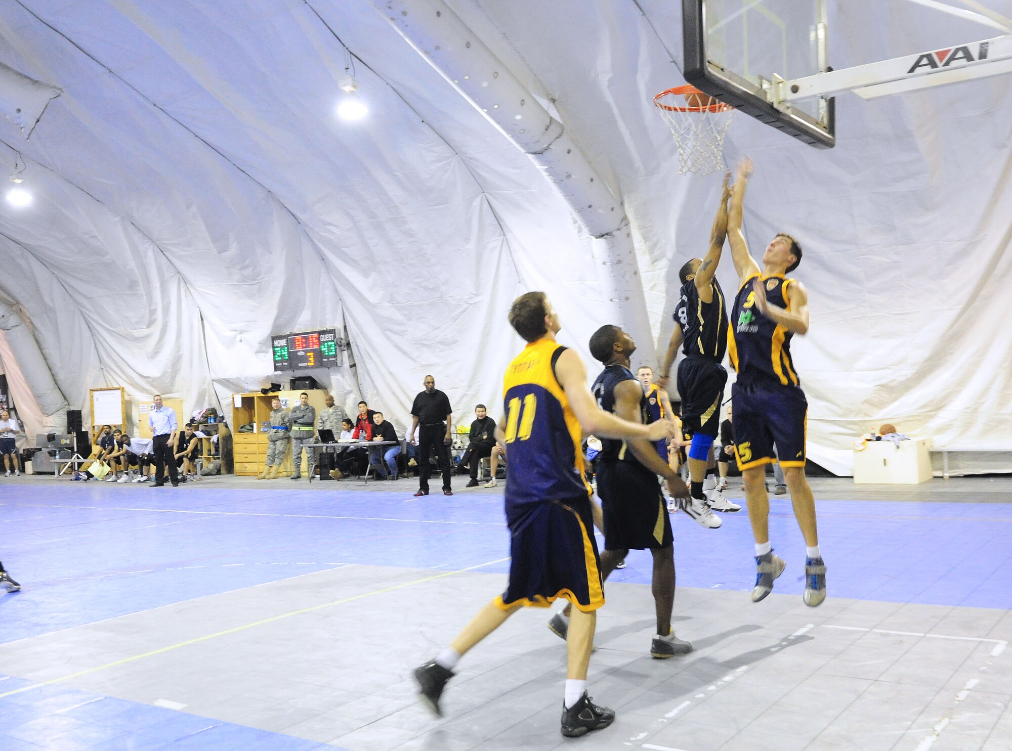 A U.S. Air Force member of the Transit Center at Manas basketball team battles for a rebound during a good will game against the Academy of Physical Culture and Sports, Jan. 19, 2010. The APCS defeated the TC team 72-55. (U.S. Air Force photo/Senior Airman Nichelle Anderson/released)