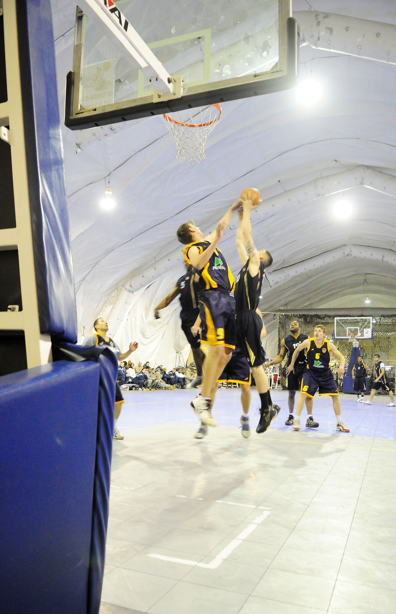 A U.S. Air Force member of the Transit Center at Manas basketball team battles for a rebound during a good will game against the Academy of Physical Culture and Sports, Jan. 19, 2010. The APCS defeated the TC team 72-55. (U.S. Air Force photo/Senior Airman Nichelle Anderson/released)