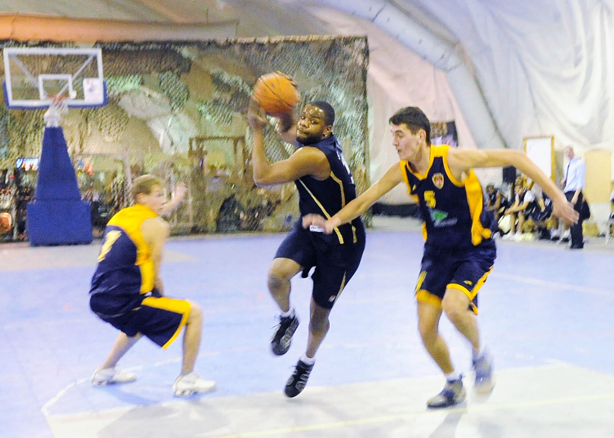 A U.S. Air Force member of the Transit Center at Manas basketball team drives the lane during a good will game against the Academy of Physical Culture and Sports, Jan. 19, 2010. The APCS defeated the TC team 72-55. (U.S. Air Force photo/Senior Airman Nichelle Anderson/released)