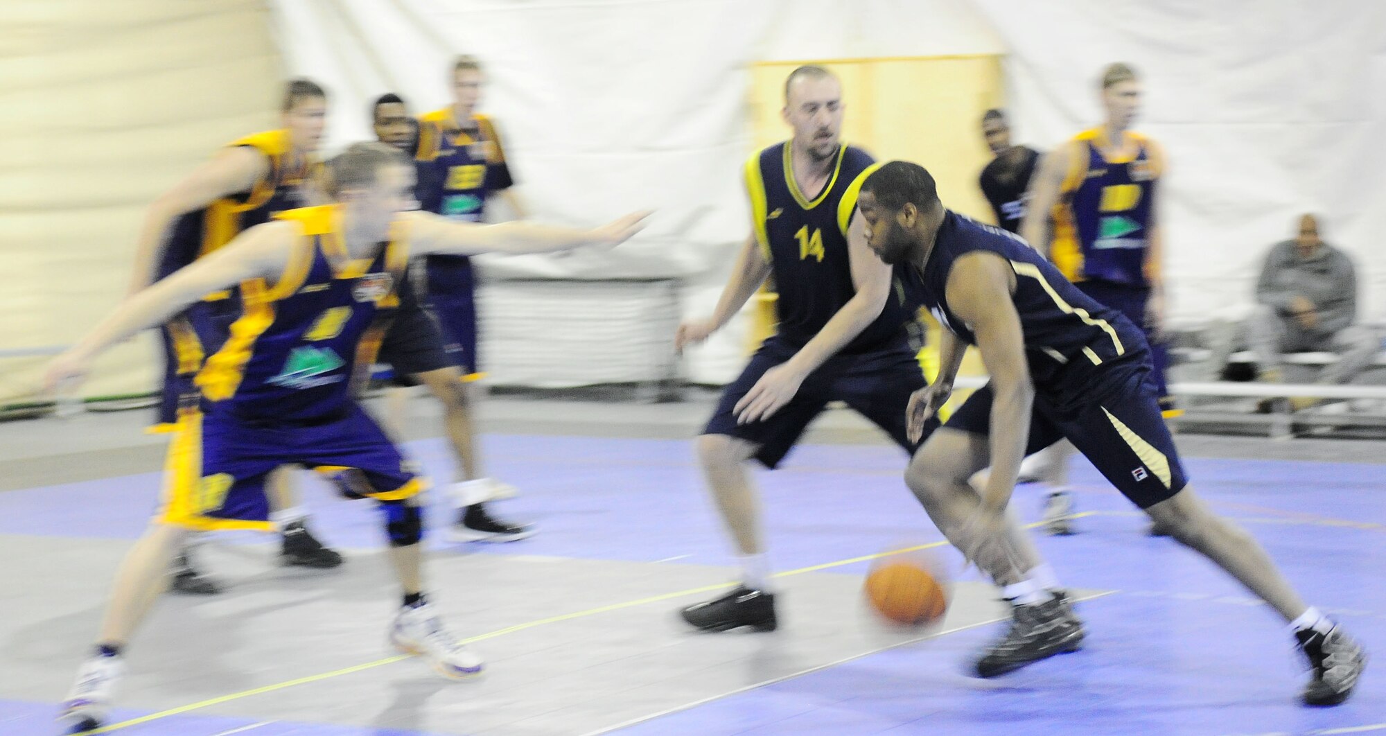 A U.S. Air Force member of the Transit Center at Manas basketball team drives the lane during a good will game against the Academy of Physical Culture and Sports, Jan. 19, 2010. The APCS defeated the TC team 72-55. (U.S. Air Force photo/Senior Airman Nichelle Anderson/released)