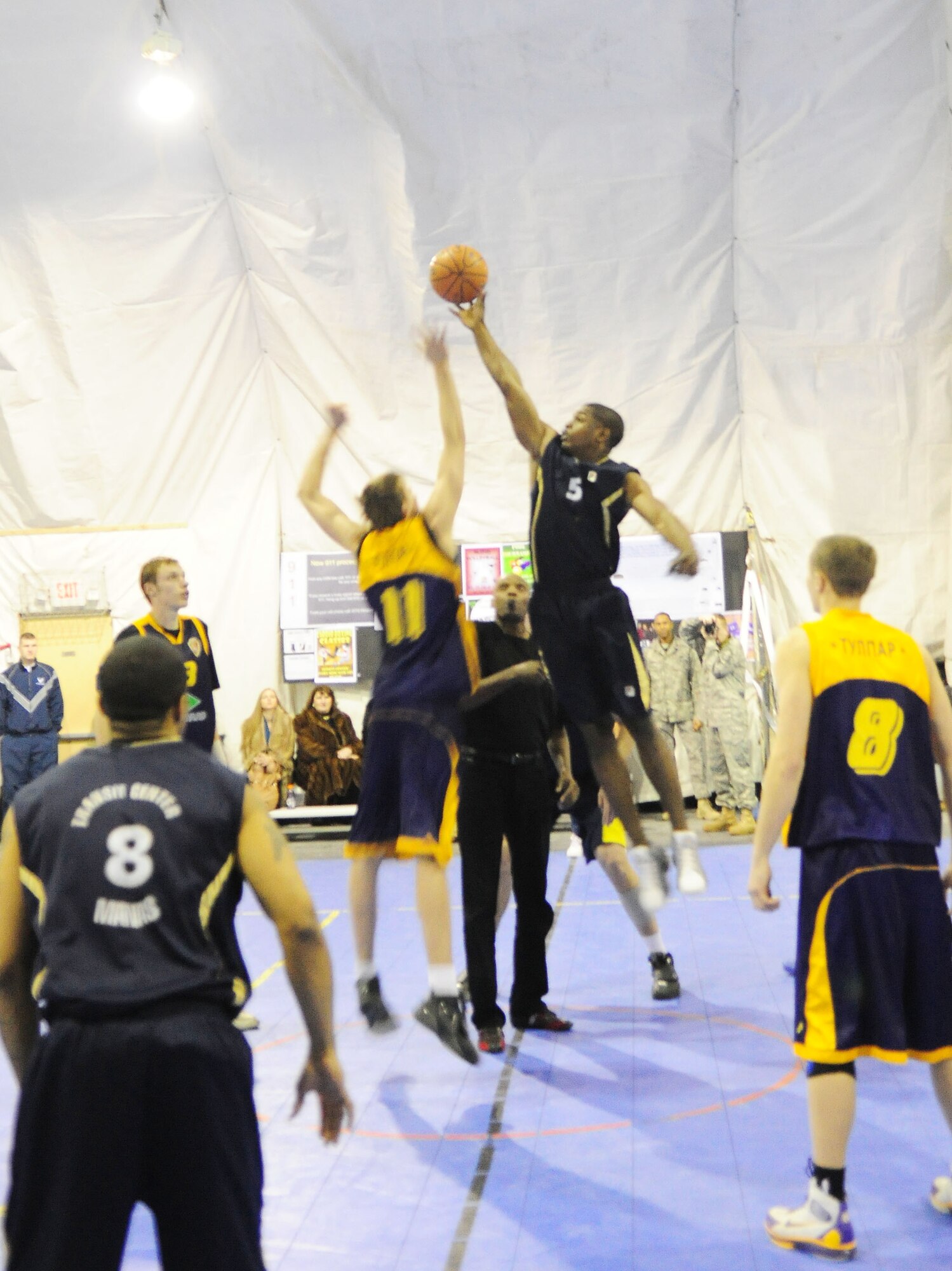 A U.S. Air Force member of the Transit Center at Manas basketball team controls the tip off to start a game against the Academy of Physical Culture and Sports, Jan. 19, 2010. The APCS defeated the TC team 72-55. In spite of the score, the good will competition was jam-packed with sportsmanship and hard play. (U.S. Air Force photo/Senior Airman Nichelle Anderson/released)