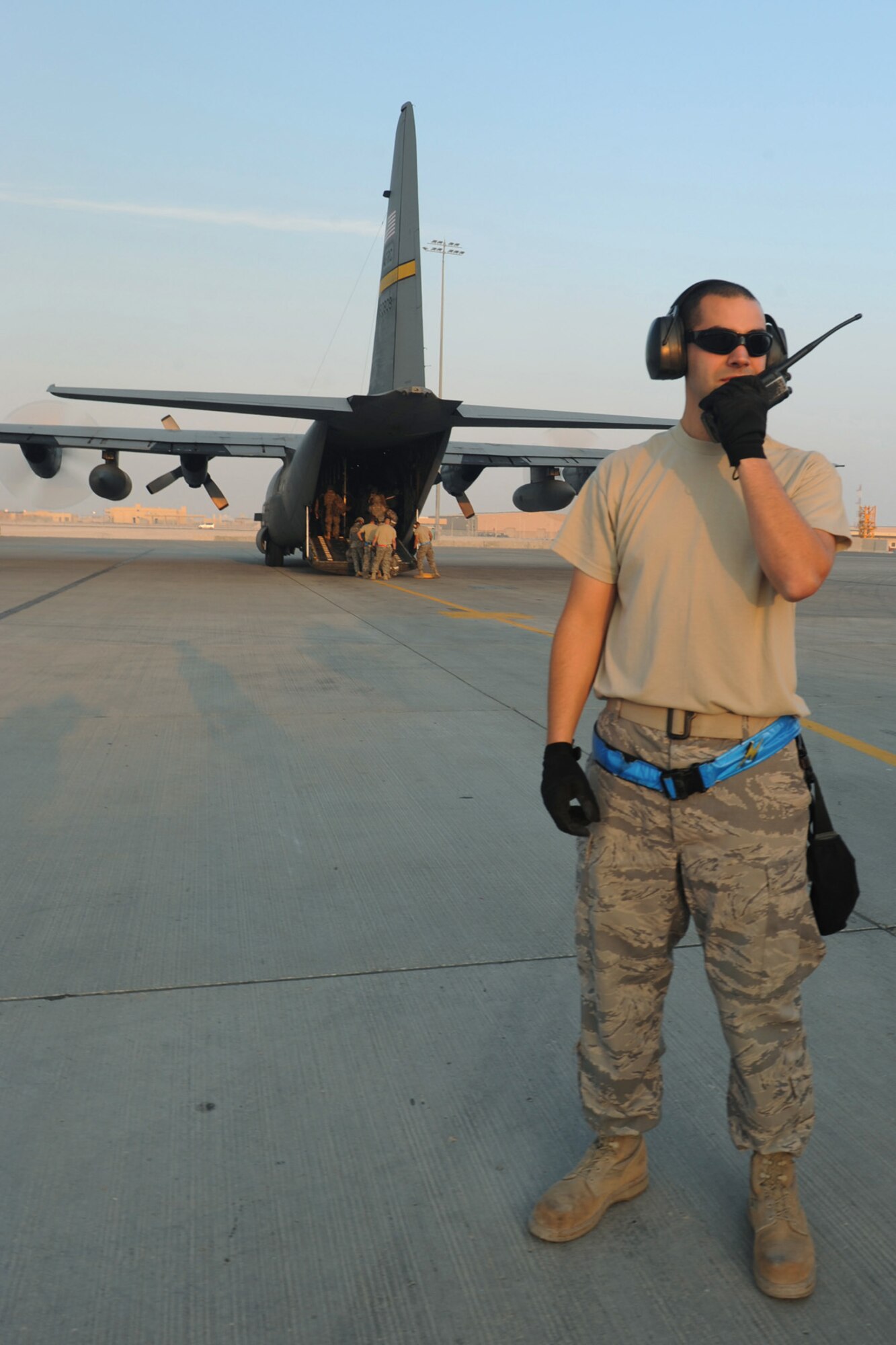 Senior Airman Stephen Wise, 8th Expeditionary Air Mobility Squadron aerial porter, prepares for an "engine running" on- and off-load of passengers and baggage from a C-130 transport plane at a non-disclosed Southwest Asia location, Jan. 18, 2010. (U.S. Air Force photo byTech. Sgt. Michelle Larche)[RELEASED]