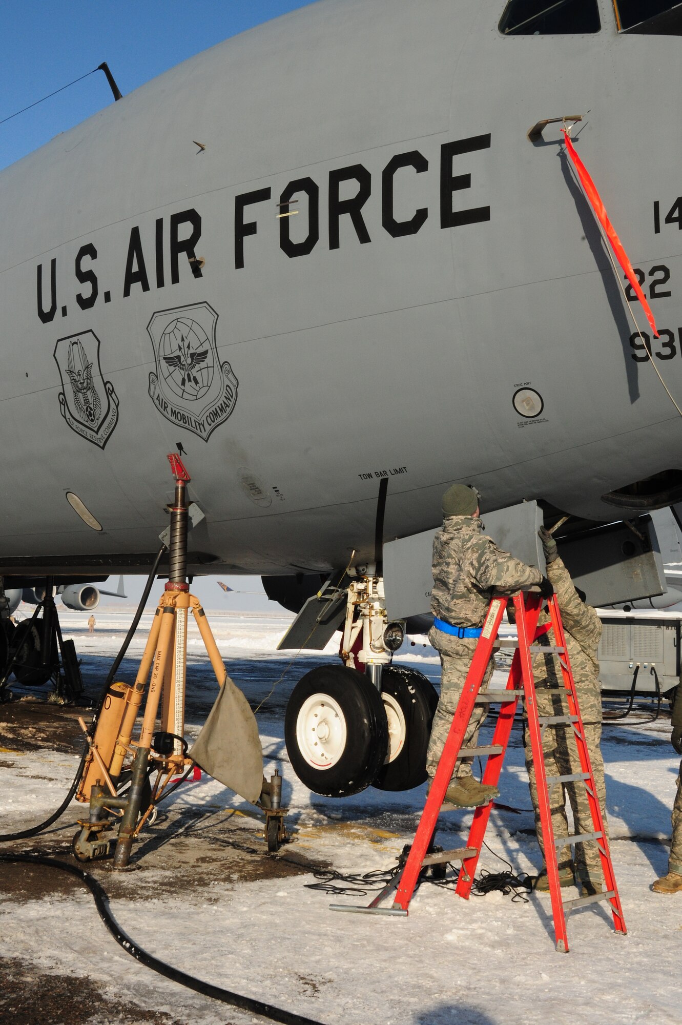 376th Expeditionary Aircraft Maintenance Squadron Airmen jack up a KC-135 Stratotanker on the flightline at the Transit Center at Manas, Kyrgyzstan, Jan. 20, 2010, to test the landing gear hydraulics. In temperatures of -8F and in spite of 10 inches of snow, Airmen here continue to ensure the wing mission gets done. The tankers here deliver hundreds of thousands of pounds of fuel to coalition combat aircraft over Afghanistan. (U.S. Air Force photo/Senior Airman Nichelle Anderson/Released)
