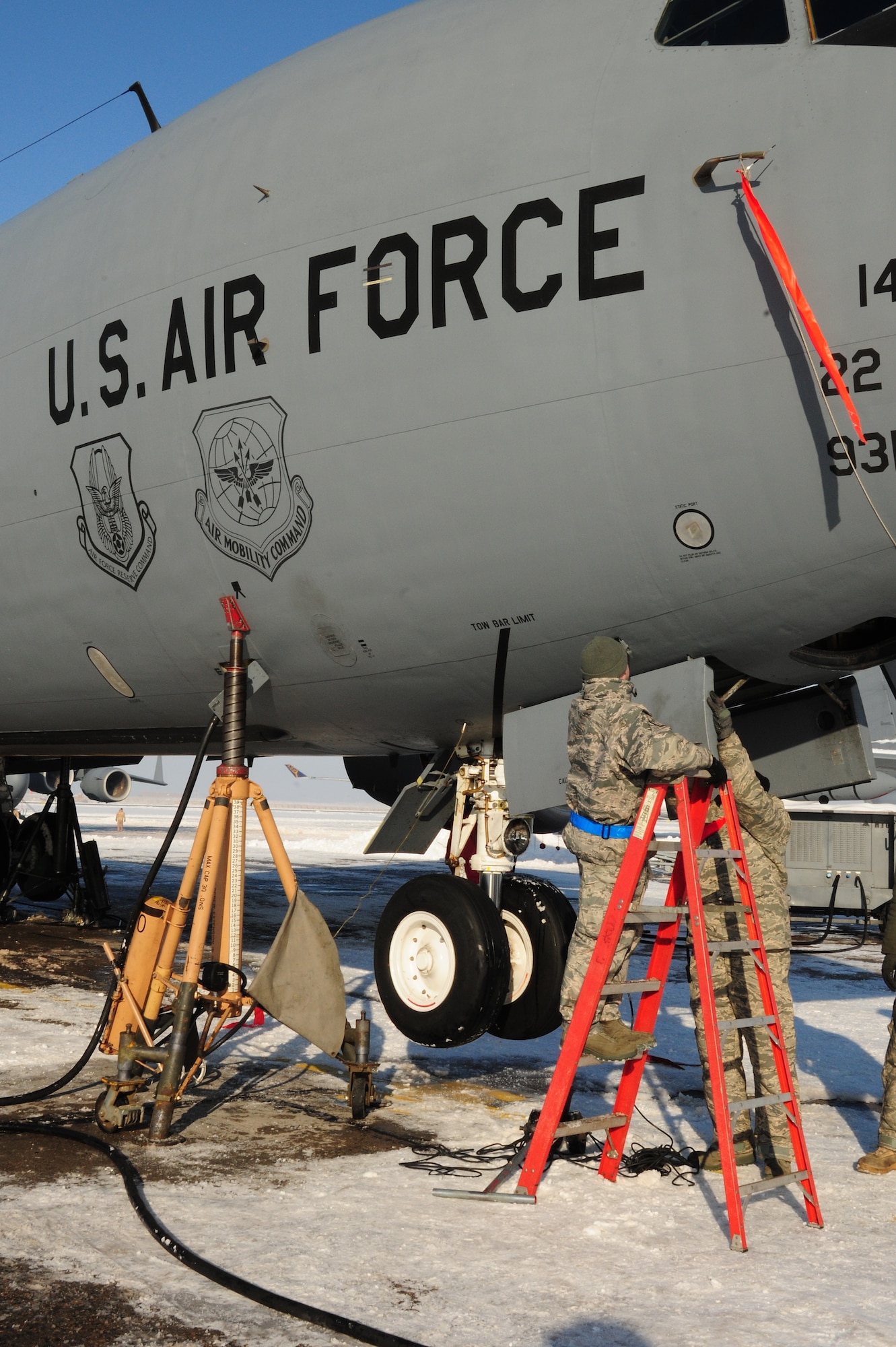 376th Expeditionary Aircraft Maintenance Squadron Airmen jack up a KC-135 Stratotanker on the flightline at the Transit Center at Manas, Kyrgyzstan, Jan. 20, 2010, to test the landing gear hydraulics. In temperatures of -8F and in spite of 10 inches of snow, Airmen here continue to ensure the wing mission gets done. The tankers here deliver hundreds of thousands of pounds of fuel to coalition combat aircraft over Afghanistan. (U.S. Air Force photo/Senior Airman Nichelle Anderson/Released)