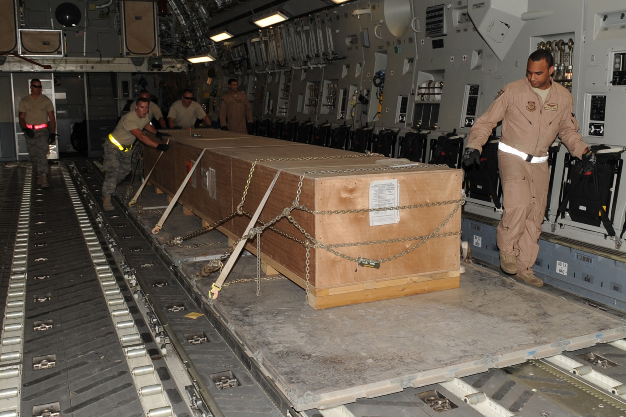 8th Expediitionary Air Mobility Squadron aerial port transporters unload equipment from a C-17 at a non-disclosed Southwest Asia location, Jan. 18, 2010. (U.S. Air Force photo byTech. Sgt. Michelle Larche)[RELEASED]