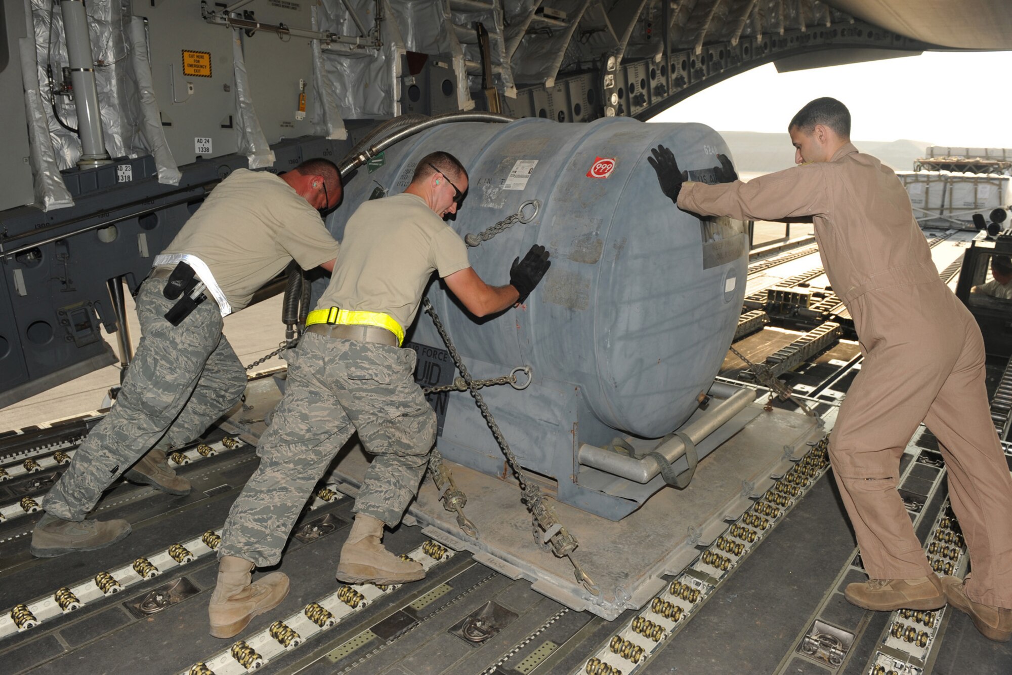 8th Expediitionary Air Mobility Squadron aerial port transporters unload equipment from a C-17 at a non-disclosed Southwest Asia location, Jan. 18, 2010. (U.S. Air Force photo byTech. Sgt. Michelle Larche)[RELEASED]