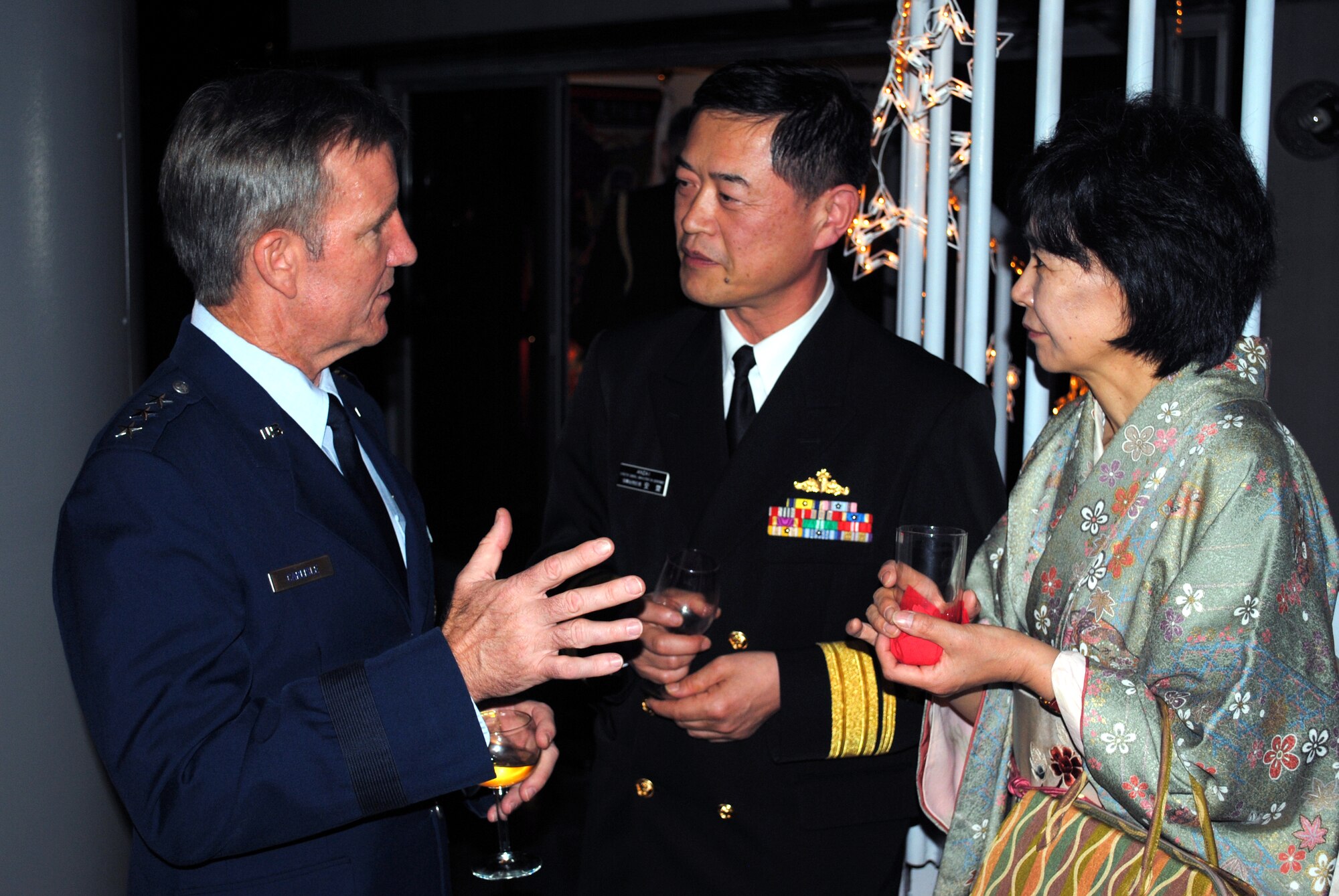 TOKYO - Lt. Gen. Hawk Carlisle, left, 13th Air Force commander, talks with Japan Rear Adm. Tsutomu Anzai, Maritime Self-Defense Force director general of administration, and his wife, Kazuko, at a U.S. Embassy reception Jan. 19 to celebrate the 50th anniversary of the signing of the Treaty of Mutual Cooperation and Security.  The treaty, signed during the height of the Cold War, gives the U.S. access to bases, infrastructure and other support in Japan in exchange for the U.S.’ commitment to aid in the cooperative defense of Japan, should an armed attack occur here. (U.S. Air Force photo/Capt. Will Powell)
