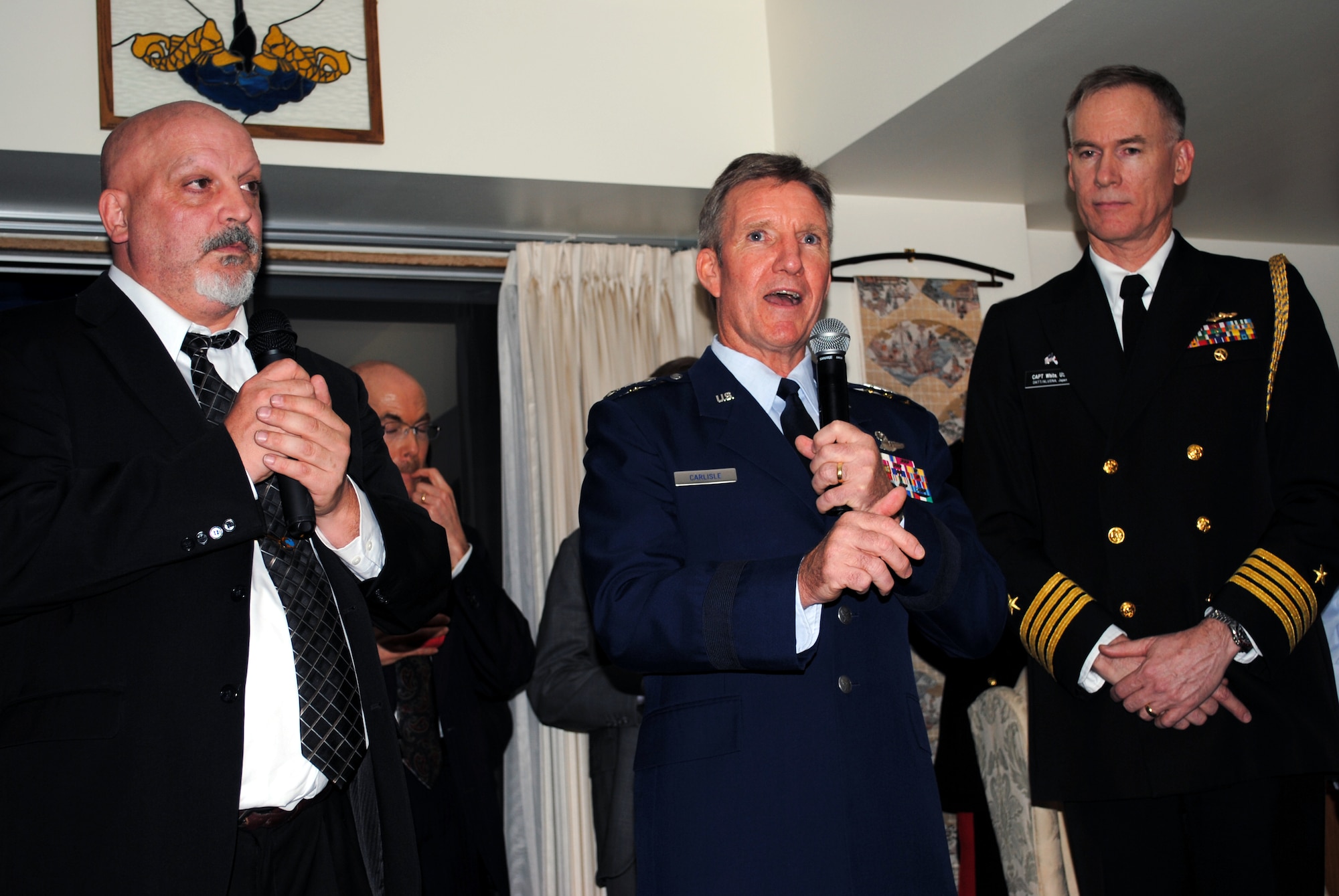 TOKYO - Lt. Gen. Hawk Carlisle, center, 13th Air Force commander, gives opening remarks Jan. 19 to a crowd of approximately 200 Japanese and American servicemembers and government officials who gathered together at the U.S. Embassy to celebrate the 50th anniversary of the signing of the Treaty of Mutual Cooperation and Security.  U.S. Navy Capt. Jim White, right, U.S. Embassy defense and naval attache, hosted the event, and Bill McGrath, left, translated General Carlisle's remarks into Japanese. (U.S. Air Force photo/Capt. Will Powell)
