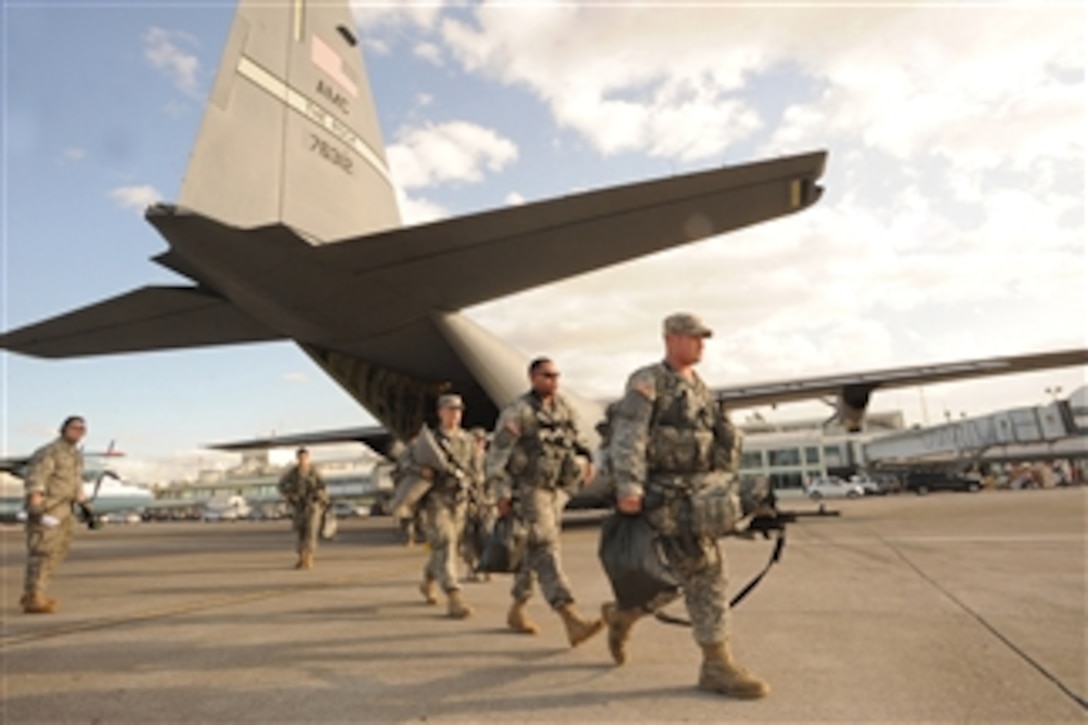 U.S. Army soldiers with the 82nd Airborne Division, Fort Bragg, N.C., arrive at Toussaint L’Ouverture International Airport in Port-au-Prince, Haiti, on Jan. 16, 2010.  The soldiers will be providing security, medical support and assisting in Haitian relief efforts after a devastating earthquake struck the country on Jan. 12, 2010.  The C-130J Hercules aircraft that delivered the soldiers to Haiti is from Little Rock Air Force Base, Ark., and is a component of Air Mobility Command.  