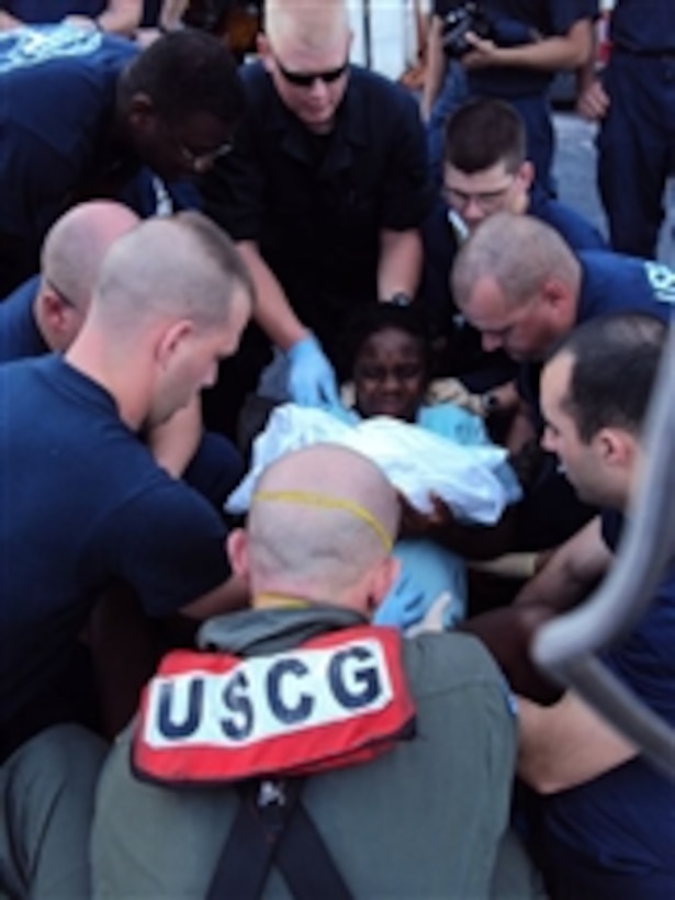 A U.S. Coast Guard helicopter crew from Air Station Clearwater, Fla., aboard USCGC Tahoma (WMEC 908) assists in the delivery of a baby in Port-au-Prince, Haiti, on Jan. 16, 2010.  A pregnant Haitian woman went into labor on the flight deck of the cutter as a Coast Guard HH-60 Jayhawk helicopter was refueling.  A rescue swimmer from the helicopter delivered the five-pound boy.  The mother and child were then taken to a hospital in Cap Haitien, Haiti, for further medical treatment.  