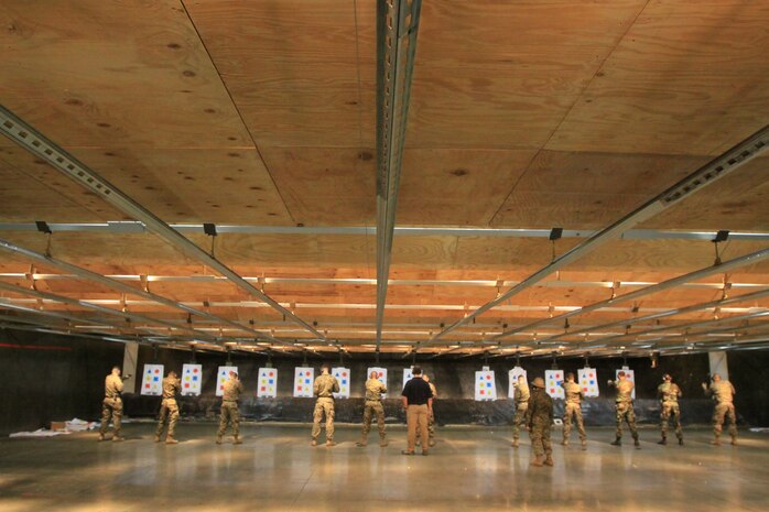 Marines and sailors stand on line during the Wolf-Tactical Reconnaissance and Personal Protection training at the Indoor Small-Arms Range here Jan 21. This past December, ISAR hosted a two week long training exercise with former members of the Isreali Special Forces. There will be more training opportunities at ISAR throughout the year.