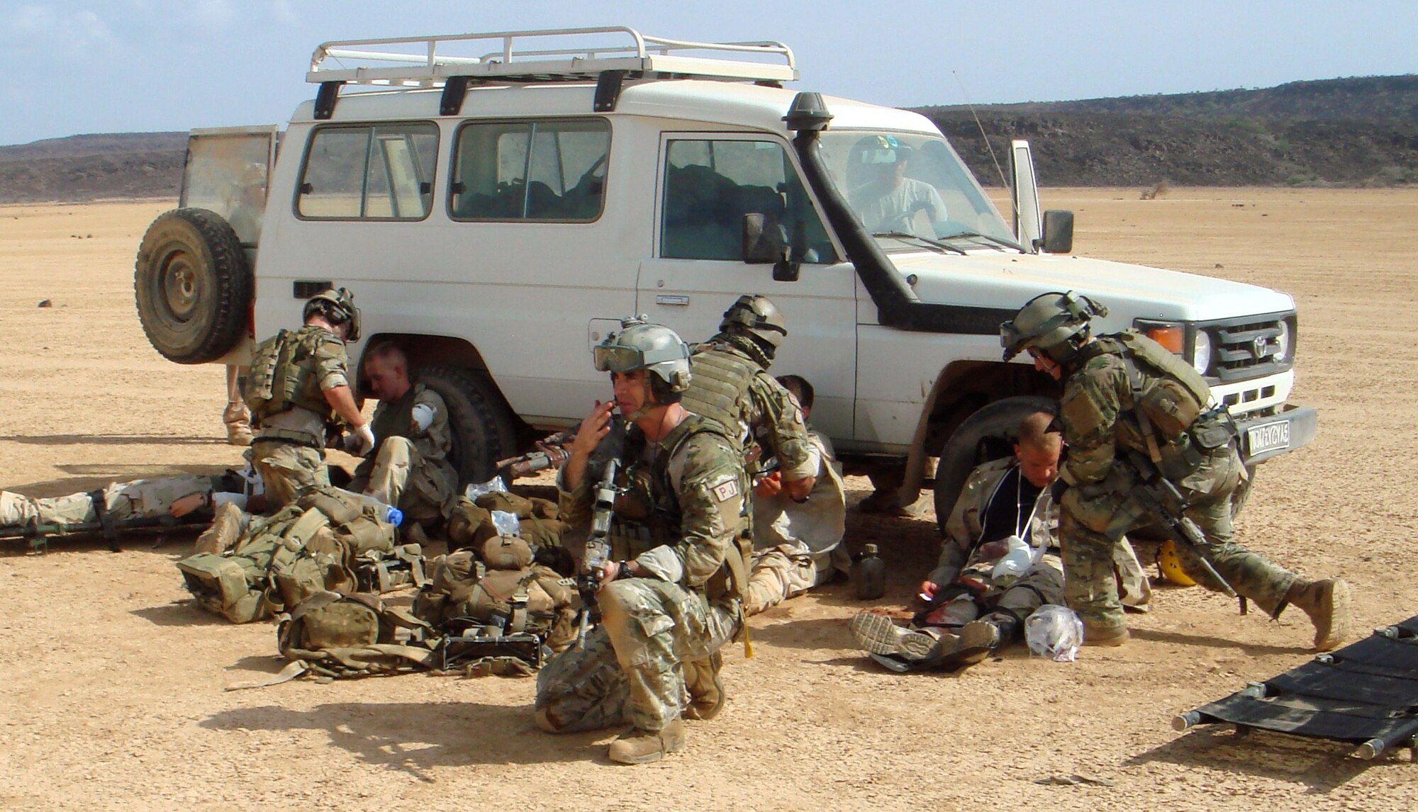Master Sgt. Rich Carroll, a pararescueman from the 31st Rescue Squadron, organizes his team's casualty collection point during a mass casualty training exercise. Sergeant Carroll led a four-man Guardian Angel team to the scene of the incident by free fall parachute and were recovered by CH-53 helicopters. (courtesy photo)