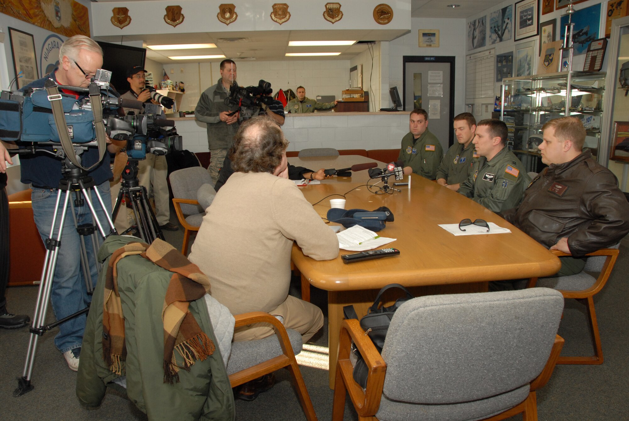 Members from the 107th New York Air National Guard and members from the 914th Air Force Reserves talk to the local media upon arriving home. The members had just completed a tour, delivering aid to Haiti. (From left to right) Staff Sgt. Brian Waite, 107th C-130 flight engineer, Capt. Justin Pautler, 107th C-130 pilot, Capt. Richard Konopczynsky, 914th C-130 pilot and Tech Sgt. Rick Ackley, 914thC-130 flight engineer. (U.S. Air Force Photo/ Tech Sgt. Cathy Perretta)