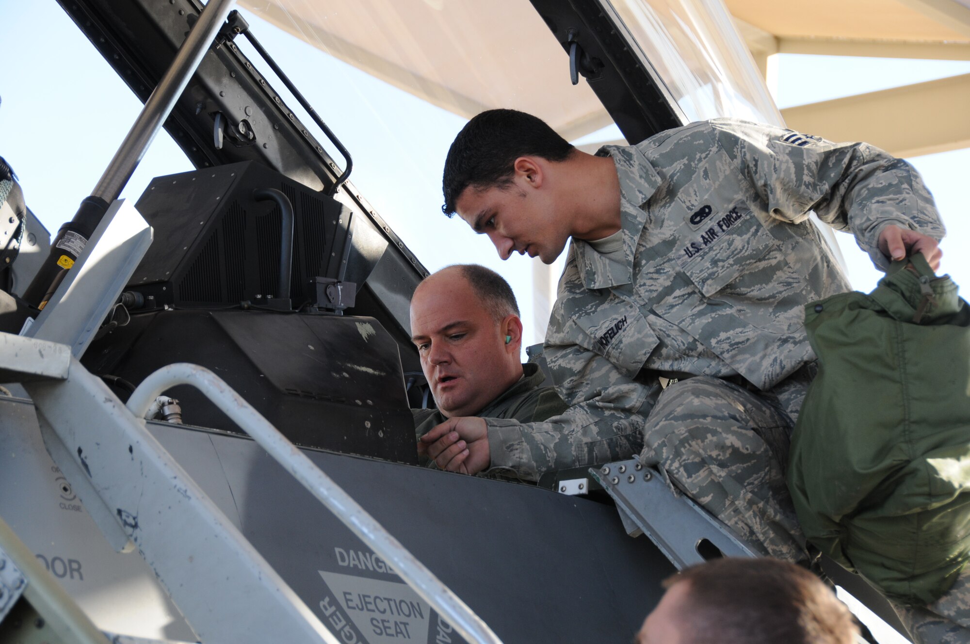 Chief Master Sgt. Dwight D. Badgett, Air Force Reserve Command command chief, listens as his crew chief gives instructions prior to his incentive flight Dec. 4, 2009. The chief said after taking an F-16 flight during his visit that he had a new appreciation for what fighter pilots go through, and why they need to be in tip-top shape. (U.S. Air Force photo/Tech. Sgt. Susan Stout)
