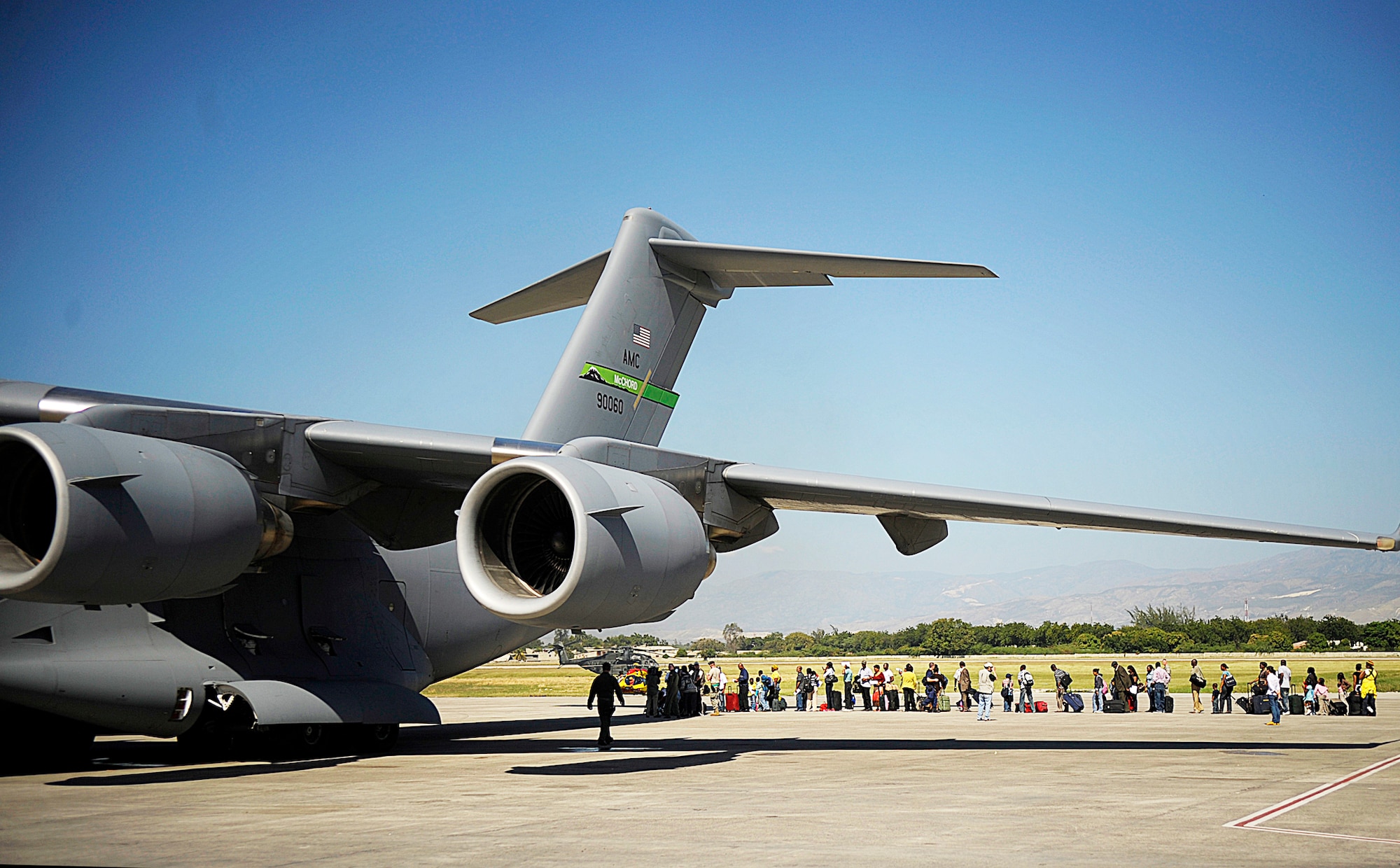 Lining up to board a C-17 Globemaster III, U.S. citizens living in Haiti evacuate from Toussaint L'Ouverture International Airport, in Port-au-Prince, Haiti, Jan. 18, 2010.  (U.S. Air Force photo/Master Sgt. Russell E. Cooley IV)
