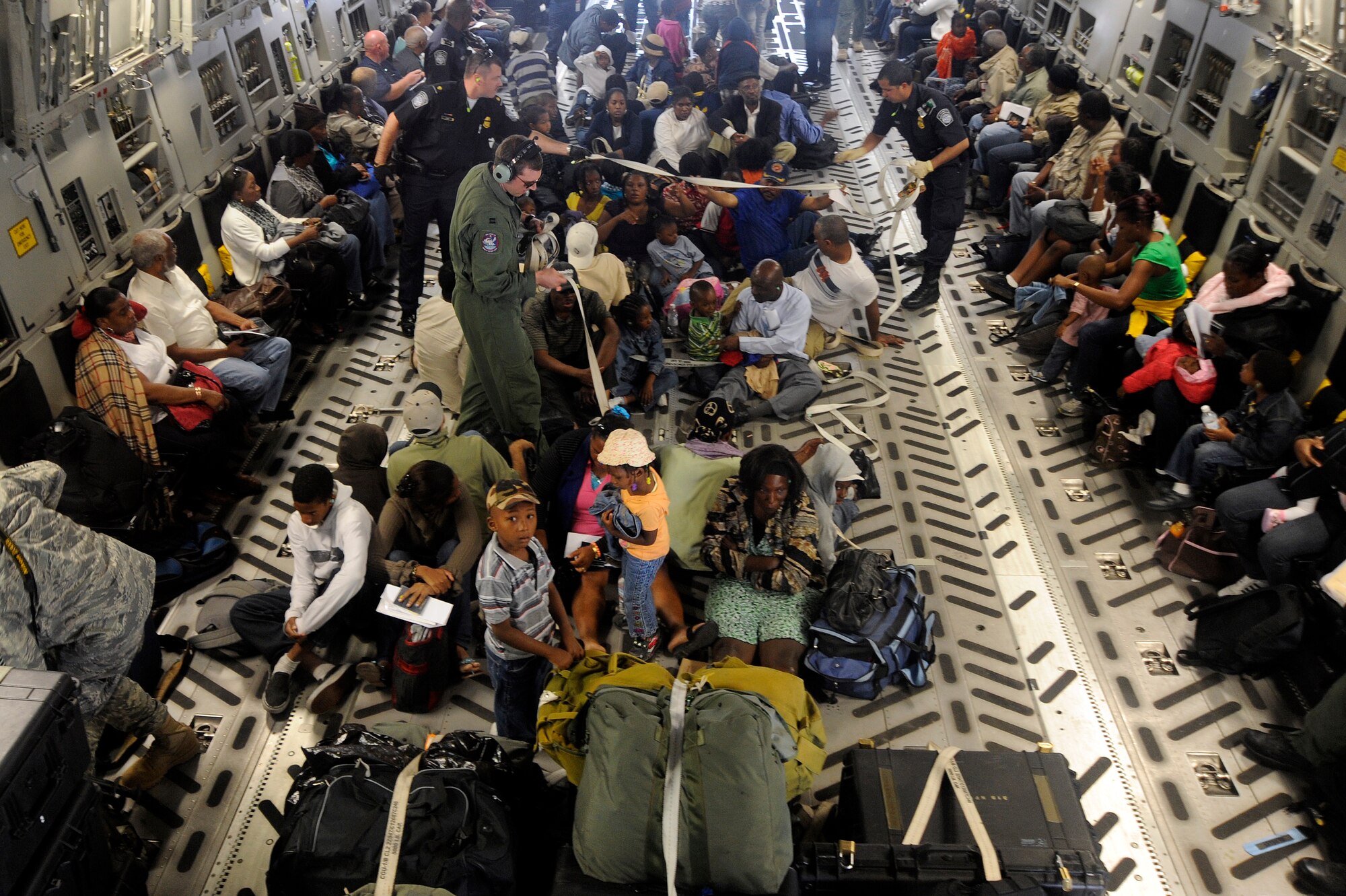 Evacuees from the earthquake that struck Haiti last week wait to exit a C-17 aircraft at Orlando Sanford International Airport Jan. 21, 2010. The C-17 was carrying over 100 evacuees from Haiti; the evacuees consisted of American and Haitian citizens.
(U.S. Air Force photo by Staff Sgt. Joseph L. Swafford Jr./Released)
