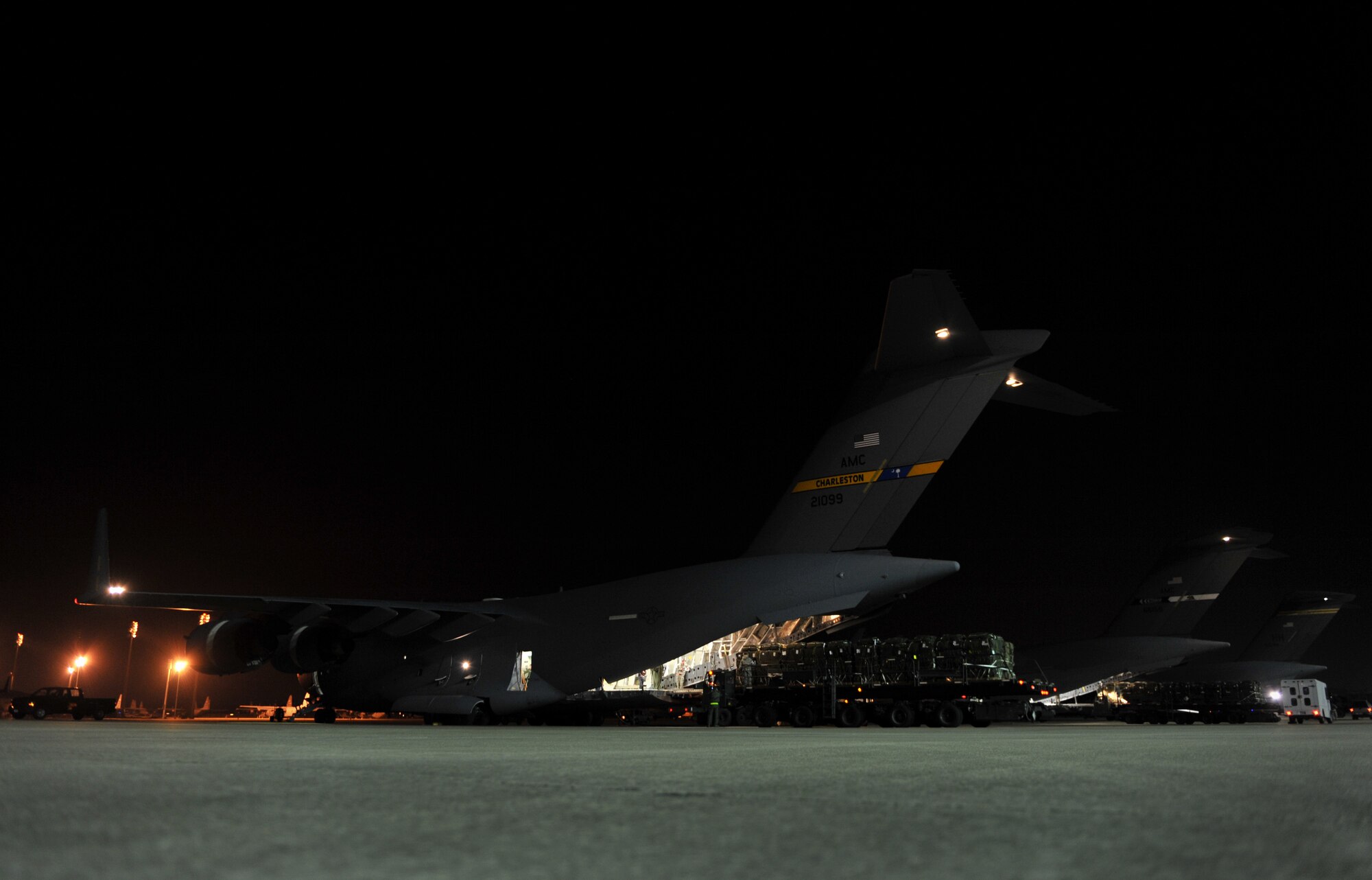 A C-17 Globemaster III is loaded with humanitarian supply pallets Jan. 21, 2010, at Pope Air Force Base, Fayetteville, N.C. The pallets will be air dropped over Haiti for a relief mission. The C-17, from Charleston Air Force Base, Charleston S.C., will be conducting a humanitarian air delivery mission over Haiti. U.S. Southern Command is deploying assets to Haiti to conduct search and rescue operations, damage assessments, and transitions sustained Humanitarian Assistance/Disaster Relief operations in order to prevent human suffering and additional loss of life. (U.S. Air Force photo/Master Sgt. Shane A. Cuomo)