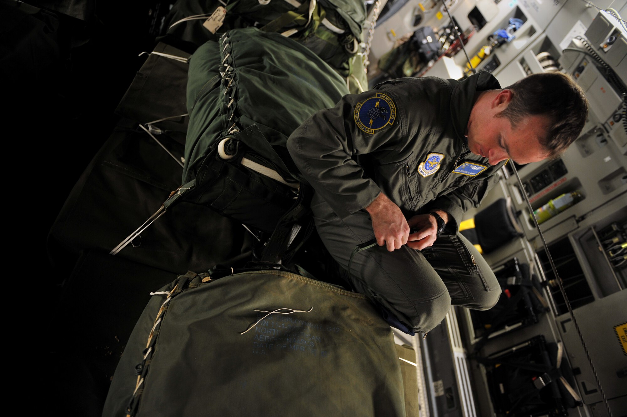 Staff Sgt. Richard Miner conducts a joint air delivery inspection on a humanitarian supply pallet Jan. 21, 2010, that is loaded on a C-17 Globemaster III at Pope Air Force Base, N.C. Sgt. Miner is a loadmaster from the 43rd Operations Support Squadron and is conducting a joint air delivery inspection on the pallets before they are air dropped over Haiti for a relief mission. The C-17, from Charleston Air Force Base, Charleston S.C., will be conducting a humanitarian air delivery mission over Haiti. U.S. Southern Command is deploying assets to Haiti to conduct search and rescue operations, damage assessments, and transitions sustained Humanitarian Assistance/Disaster Relief operations in order to prevent human suffering and additional loss of life. (U.S. Air Force photo/Master Sgt. Shane A. Cuomo)