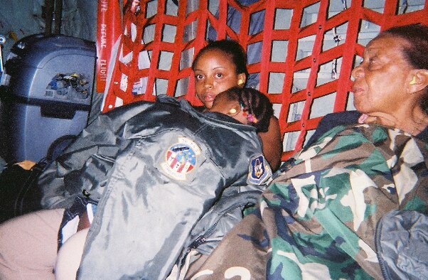 Evacuees from Haiti warm up on an Air Force Reserve C-130 Hercules after being evacuated Jan. 17 from Port-au-Prince, Haiti. The evacuees traveled to Fort Lauderdale, Fla. on a 302nd Airlift Wing-operated C-130 that supported Haiti earthquake relief operations. Prior to theevacuation flight, the wing delivered Soldiers from the 82nd Airborne Division, based at Ft. Bragg, N.C. (U.S. Air Force photo/Tech. Sgt. Kevin Kolln)