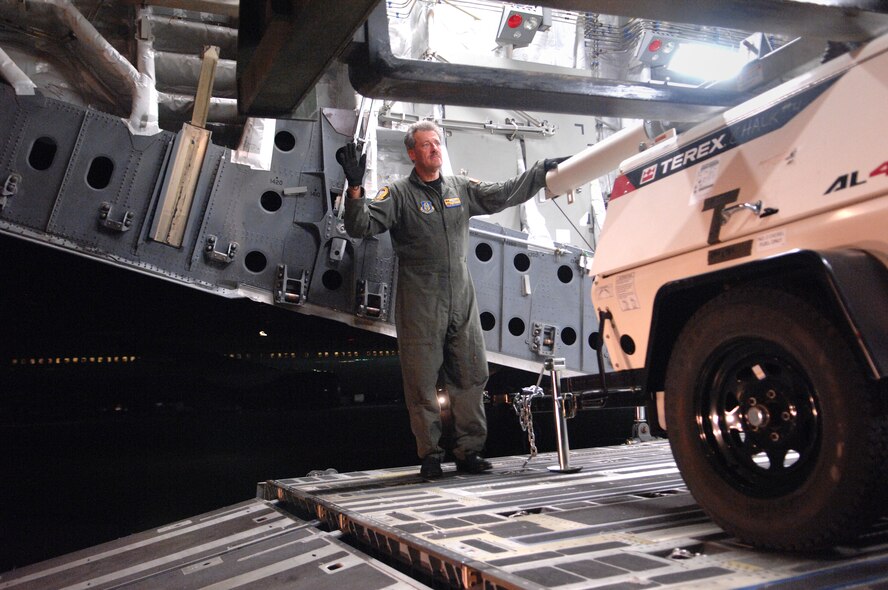 U. S Air Force Senior Master Sgt. William J. Lamela, Load Master for a C-17A Globemaster from the 729th Airlift Squadron, out of March Air Reserve Base, directs the off loading of equipment and supplies Sunday, January 17th, 2010, at the Port-au-Prince International Airport, Haiti. The C-17A and crew, both out of the 452nd Air Mobility Wing at March Air Reserve Base, are taking part in the massive international effort to assist in rescue, recover and humanitarian efforts following a 7.0 earthquake. President Barack Obama ordered a swift and aggressive rescue effort.  The January 12, 2010 quake, centered near the island nation's capital of Port-au-Prince, has left untold numbers of residents homeless, injured or dead.(U.S. Air Force photo by Master Sgt. Dawn Price/released)