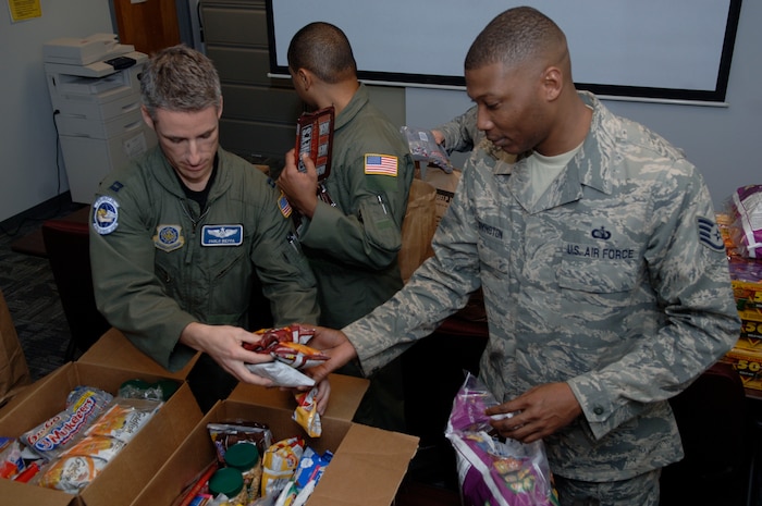 Members of Team Charleston load boxes of snacks at Charleston AFB for the C-17 crews to give to evacuees Jan. 21. Aircrews and families from Charleston AFB all collaborated to support the humanitarian relief efforts in Haiti .  (U.S. Air Force photo/Airman 1st Class Lauren Main)