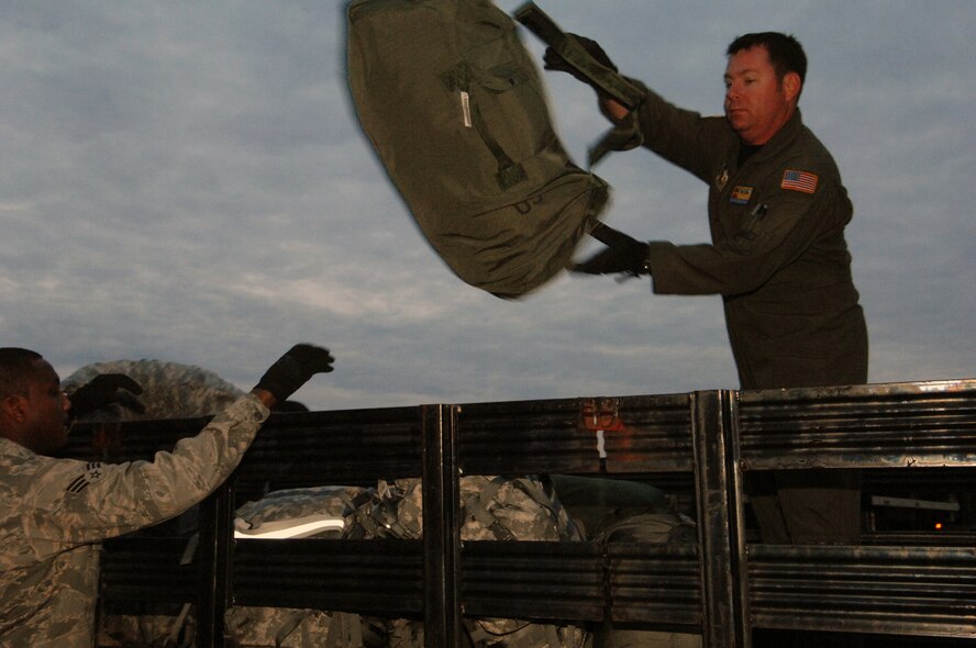 U. S Air Force Senior Technical Sgt. Michael Giles, Load Master for the C-17A Globemaster from the 729th Airlift Squadron, out of March Air Reserve Base, moves seabags Saturday, January 16th, 2010, bound for Port-au-Prince International Airport, Haiti. The C-17A and crew, both out of the 452nd Air Mobility Wing at March Air Reserve Base, are taking part in the massive international effort to assist in rescue, recover and humanitarian efforts following a 7.0 earthquake. President Barack Obama ordered a swift and aggressive rescue effort.  The January 12, 2010 quake, centered near the island nation's capital of Port-au-Prince, has left untold numbers of residents homeless, injured or dead.(U.S. Air Force photo by Master Sgt. Dawn Price/released)