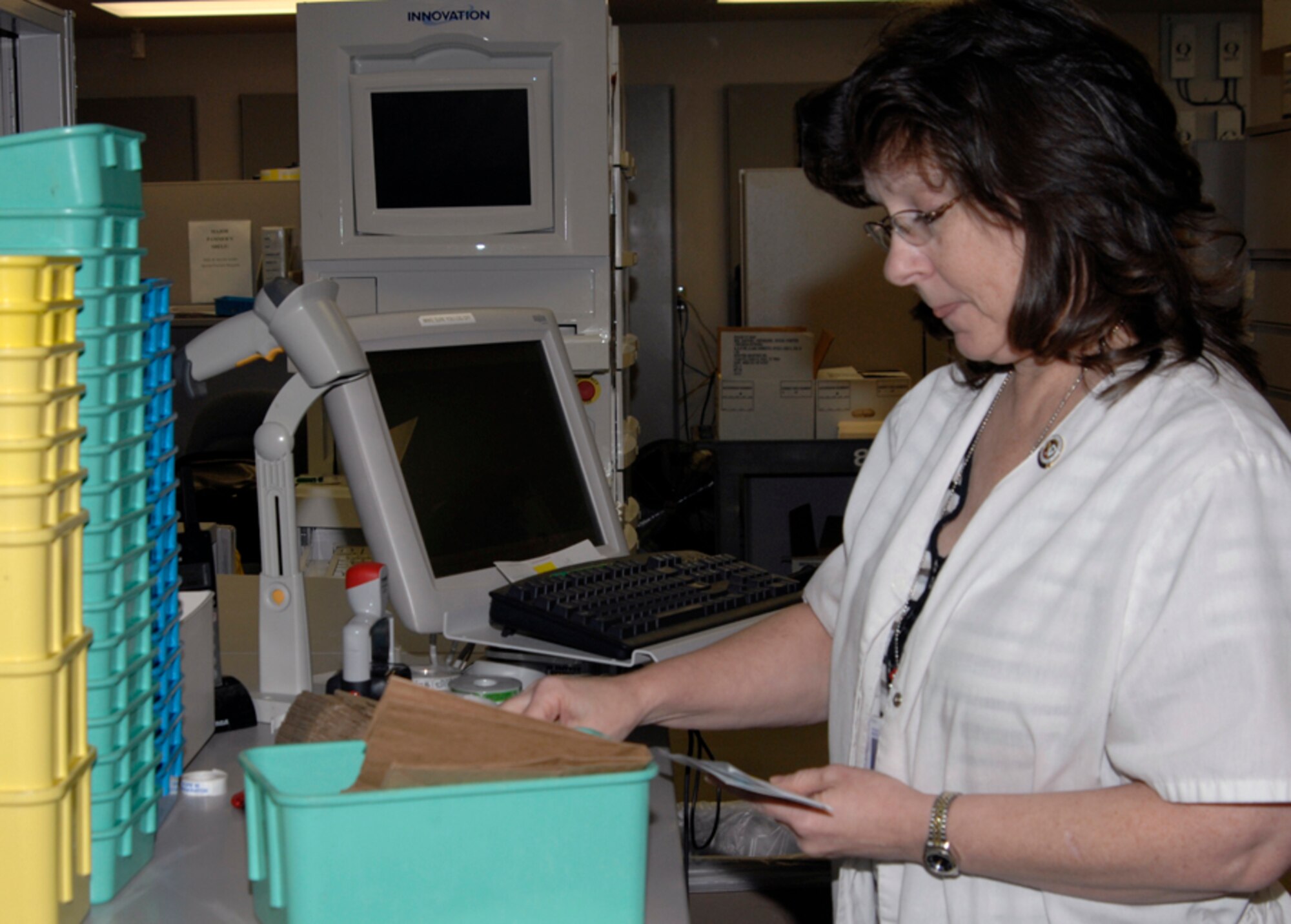 Lisa Klein, a 22nd Medical Support Squadron pharmacy technician, inspects labels before they are placed on prescription medication bottles at the base pharmacy Jan. 5, 2010, at McConnell Air Force Base, Kan. The base pharmacy has a drug-dispensing robot dubbed Sally, which fills and labels orders at a rate of 230 prescriptions per hour. (U.S. Air Force Photo/Airman 1st Class Justin Shelton)