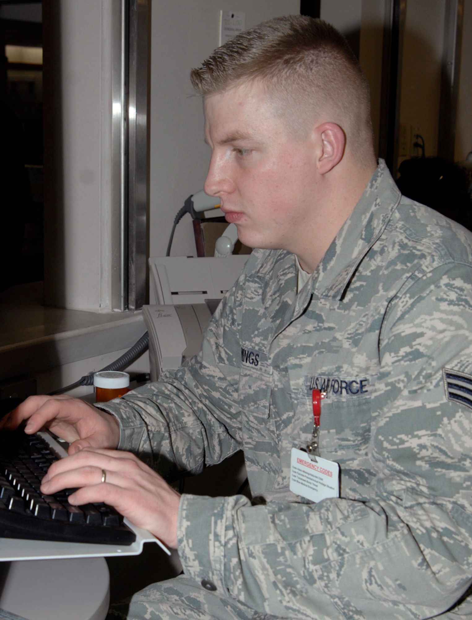 Senior Airman Calvin Cummings, a 22nd Medical Support Squadron pharmacy technician, manages and verifies prescription medication orders at the clinic pharmacy’s customer service window Jan. 5, 2010, at McConnell Air Force Base, Kan. After doctors log prescriptions for clinic patients, pharmacy technicians make sure the patients know what drugs and dosage instructions they are receiving.  On average, the pharmacy fills 3,250 prescriptions each week. (U.S. Air Force Photo/Airman 1st Class Justin Shelton)