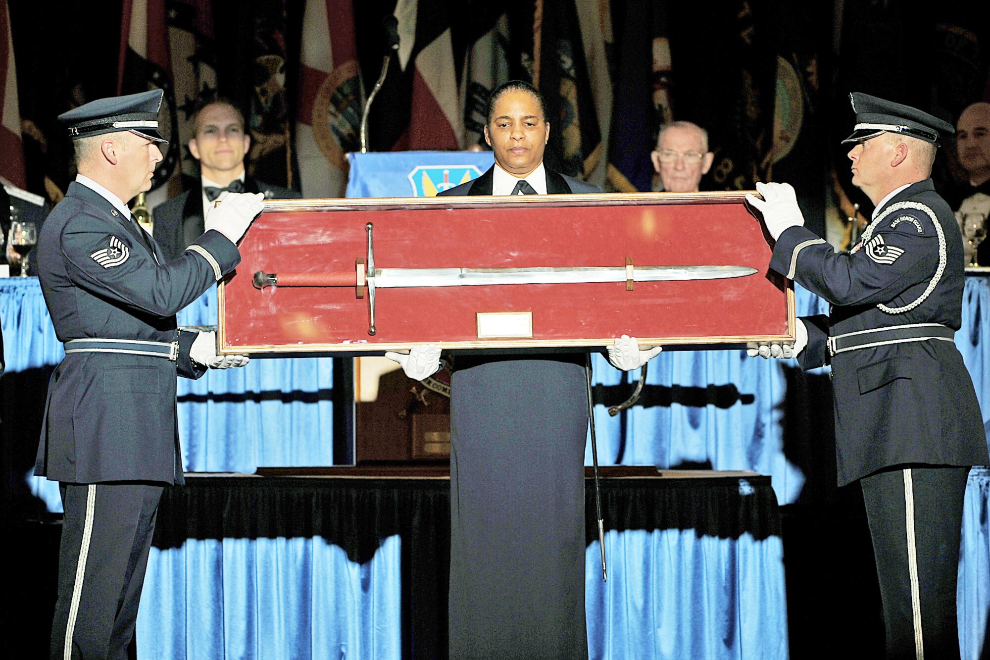 Tech. Sgt. Chris Ellis, Chief Master Sgt. Shelina Frey and Tech. Sgt. Troy Bizzack present the sword during the Air Combat Command Order of the Sword ceremony Jan. 13, 2010 in Omaha, Neb. The honor was established by the Air Force enlisted corps to recognize and honor senior officers (colonels or above) and civilian equivalents. Sergeant Ellis is the base honor guard superintendent at Dyess Air Force Base,Texas. Sergeant Bizzack is the honor guard NCO in charge at Holloman AFB, N.M. (U.S. Air Force photo/Charles Haymond)
