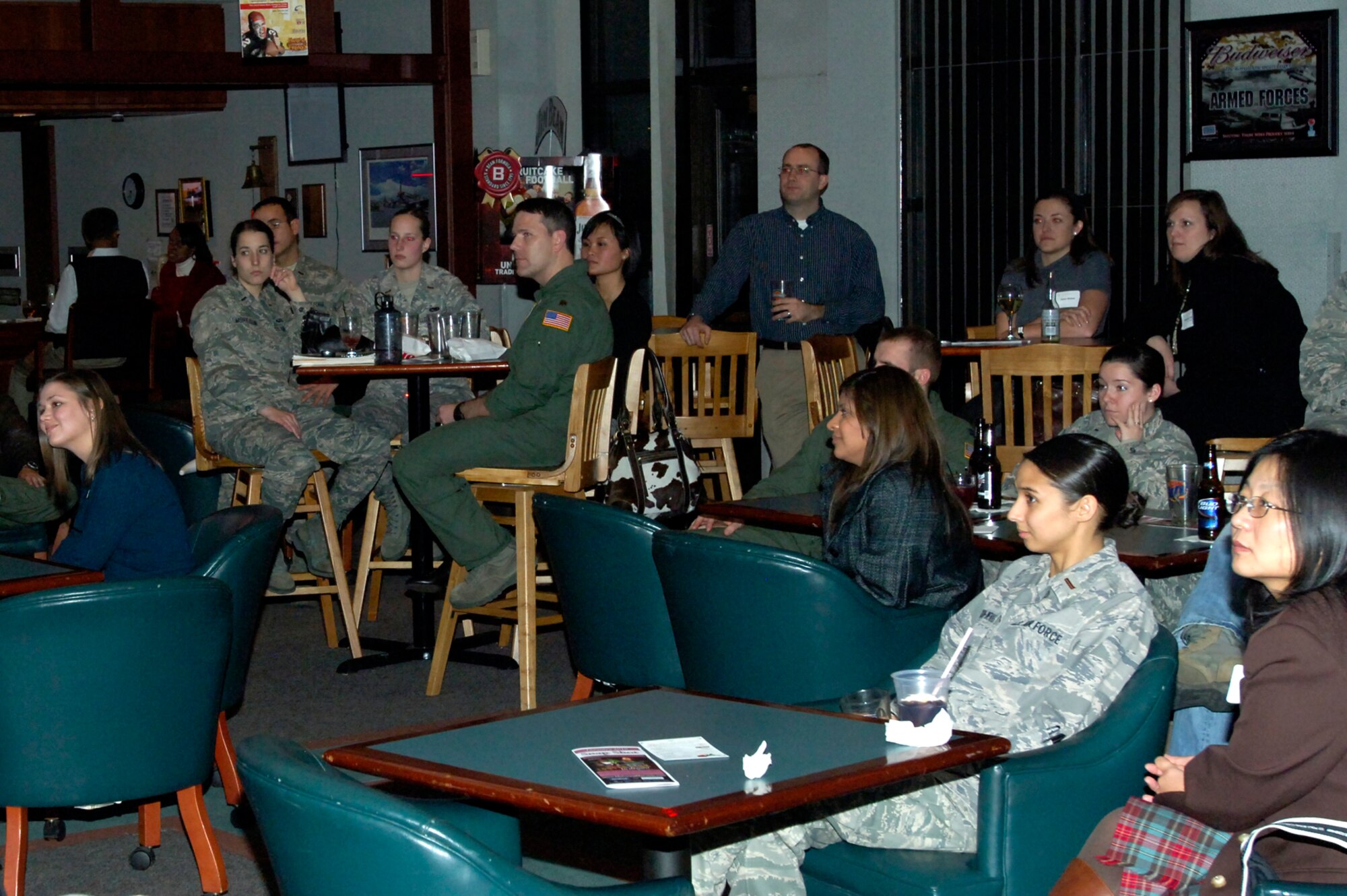 Members of the Company Grade Officer's Council at McConnell Air Force Base host the Young Professionals of Wichita at the Storm Cellar Sports Bar, Jan. 14. YPW is a community-based organization that offers innovative ways for young professionals in the Wichita area to connect socially. After watching a McConnell mission brief, the guests and hosts enjoyed getting to know one another. (U.S. Air Force photo/1st Lt. Nicholas Mercurio)