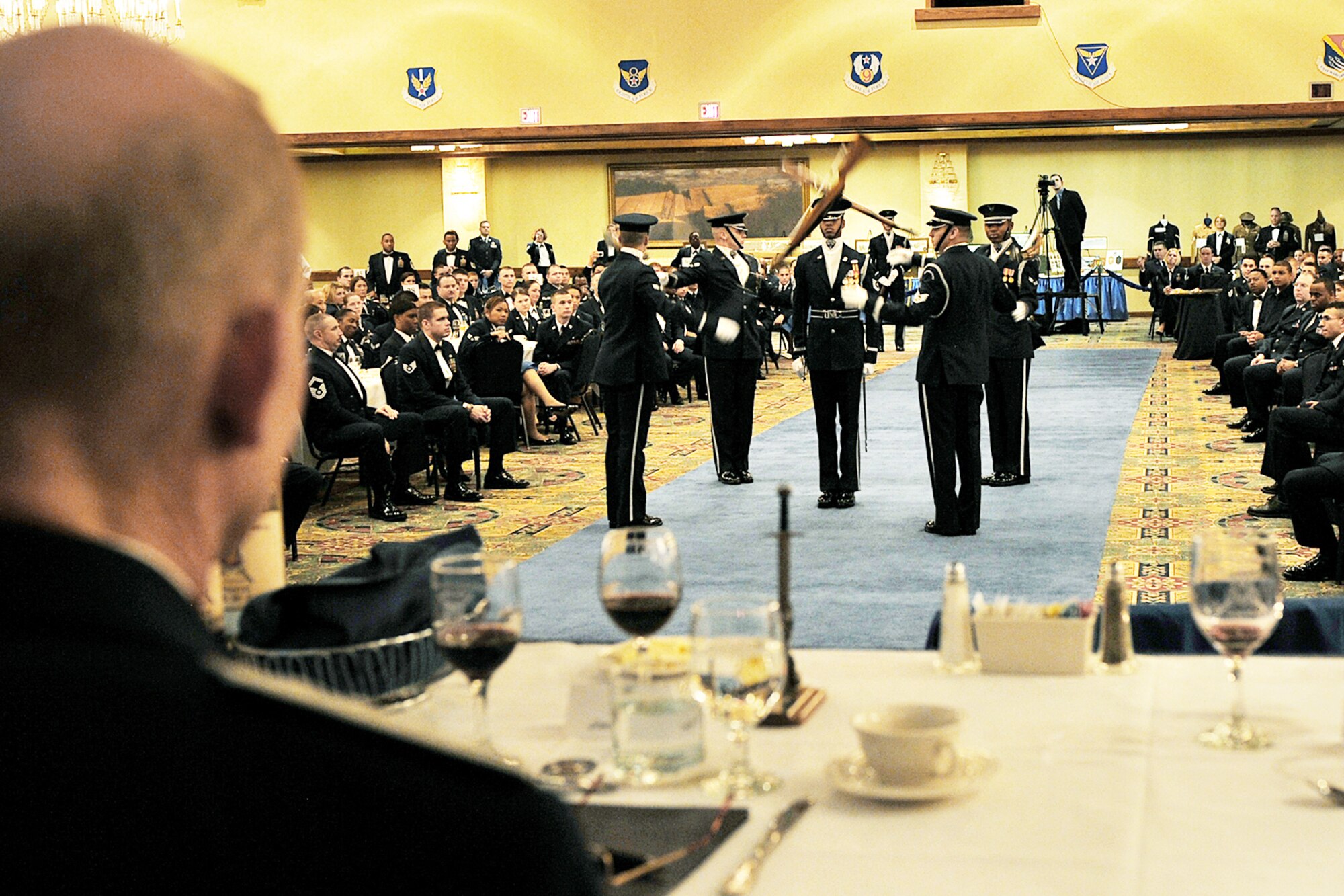Retired General John D.W. Corley looks on as the Air Force Honor Guard drill team performs during the Air Combat Comand Order of the Sword ceremony Jan. 13, 2010, in Omaha, Neb. General Corley is the former commander of ACC. (U.S. Air Force photo/Charles Haymond)
