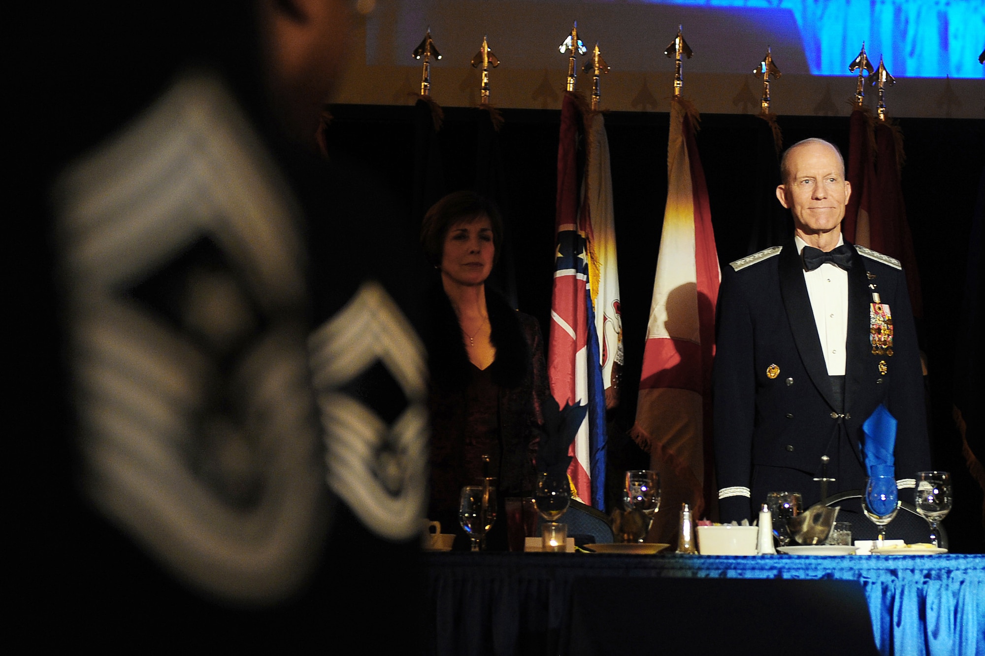 Retired Gen. John D.W. Corley stands at the head table with his wife, Alice, while the audience of 500 enlisted Airmen look on during an Order of the Sword Ceremony Jan. 13, 2010 in Omaha, Neb. The Order of the Sword is the highest award presented by the Air Force enlisted corps. General Corley is the former commander of Air Combat Command. (U.S. Air Force photo/Josh Plueger)
